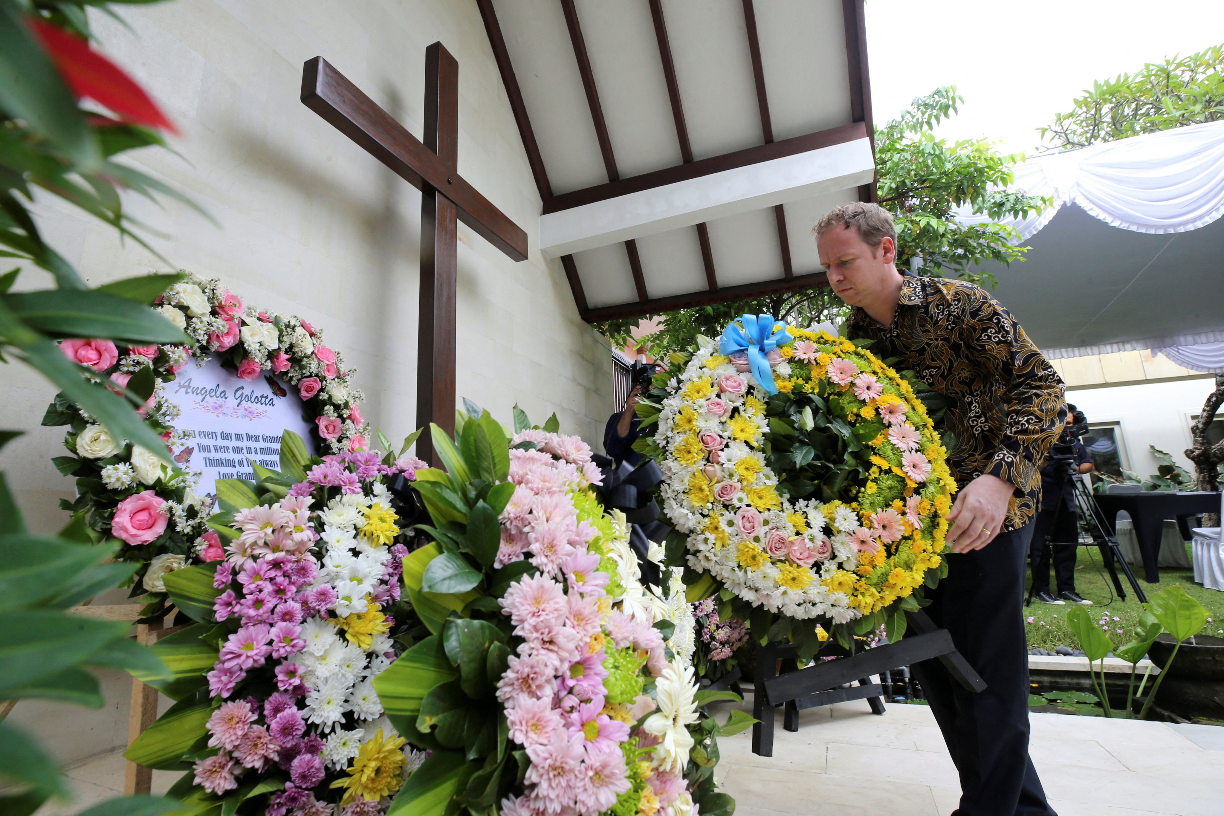A victim’s relative lays a wreath during the commemoration of the 20th anniversary of the Bali bombing that killed 202 people, including 88 Australians, at the Australian Consulate in Denpasar, Bali, Indonesia, on October 12, 2022. Photo: Pool via Reuters