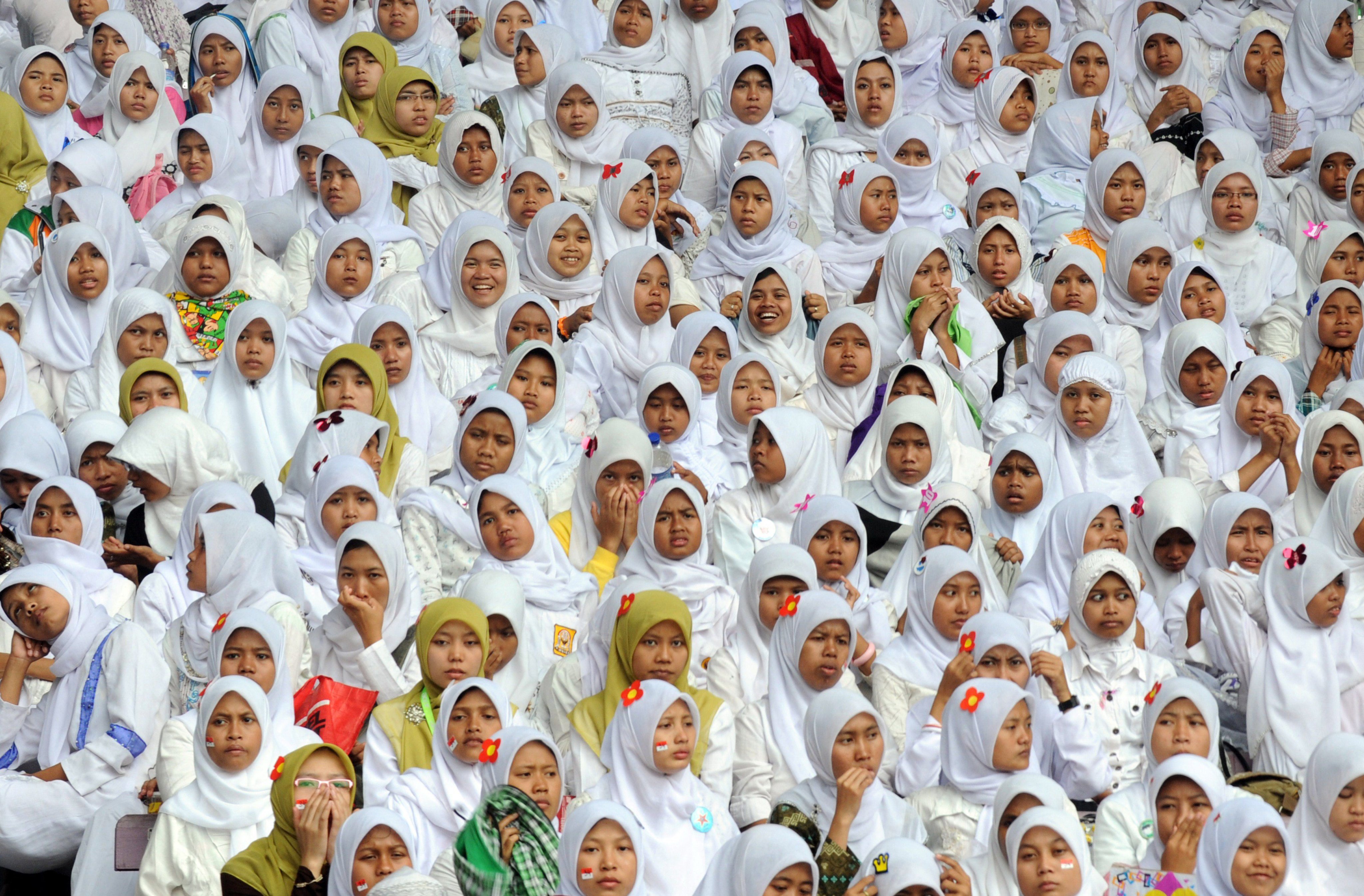 Young women attending a ceremony at a stadium in Jakarta. Experts say extremist groups prey on young women and manipulate their emotional vulnerability. Photo: AFP