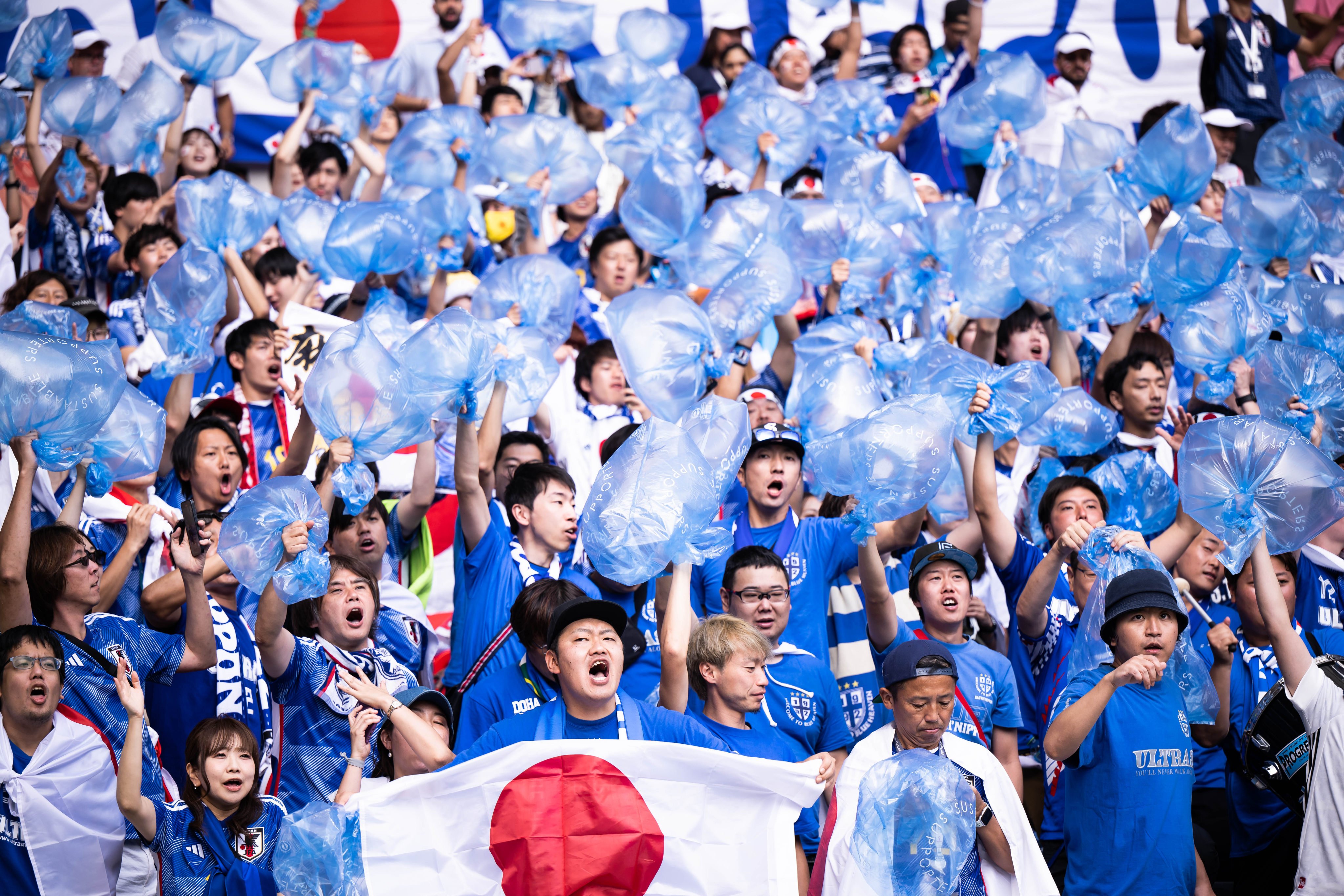 Japanese fans show the rubbish bags they brought with them for cleaning the stadium in Qatar prior to the Fifa World Cup Qatar 2022 match between Japan and Costa Rica. Photo: Marvin Ibo Guengoer - GES Sportfoto/Getty Images