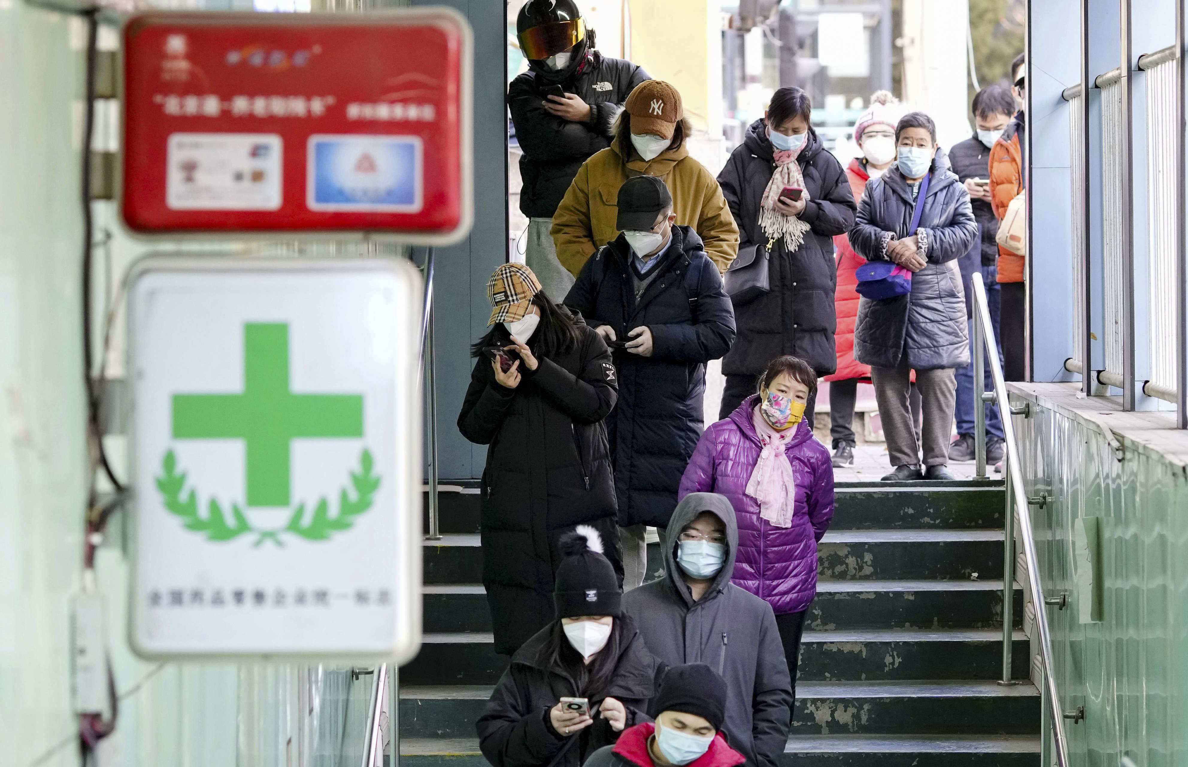 People form a long line at a pharmacy in Beijing on Thursday, bracing for a possible surge in Covid-19. Photo: Kyodo
