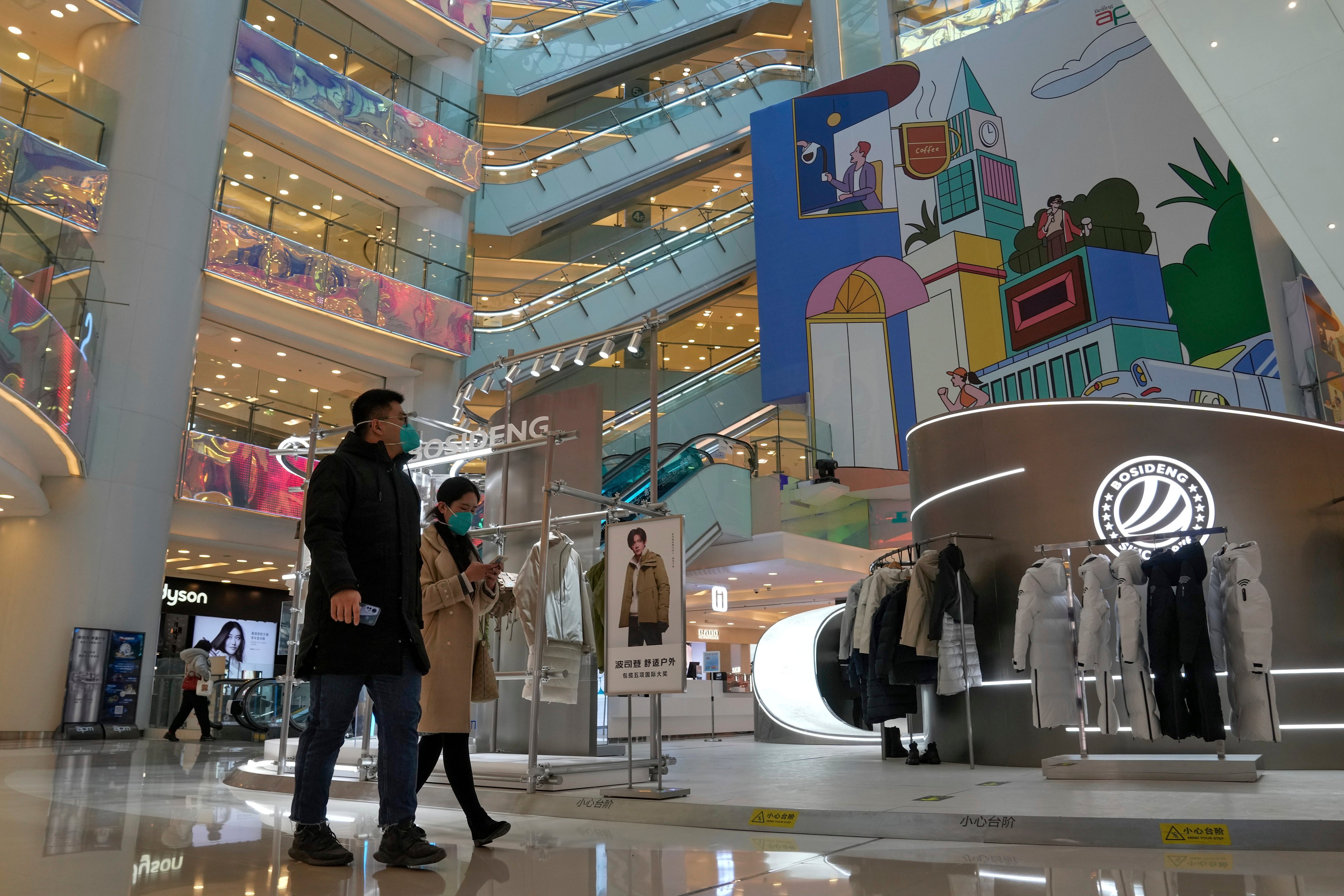 Shoppers in a Beijing shopping mall after the capital started to ease its restrictions. Photo: AP