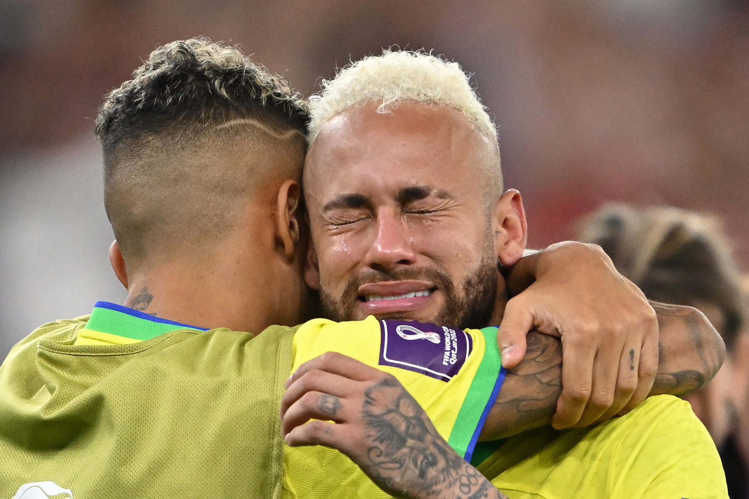 Brazil’s Raphinha comforts teammate Neymar as he cries following their team’s defeat in the World Cup quarter finals on Saturday. Photo: dpa