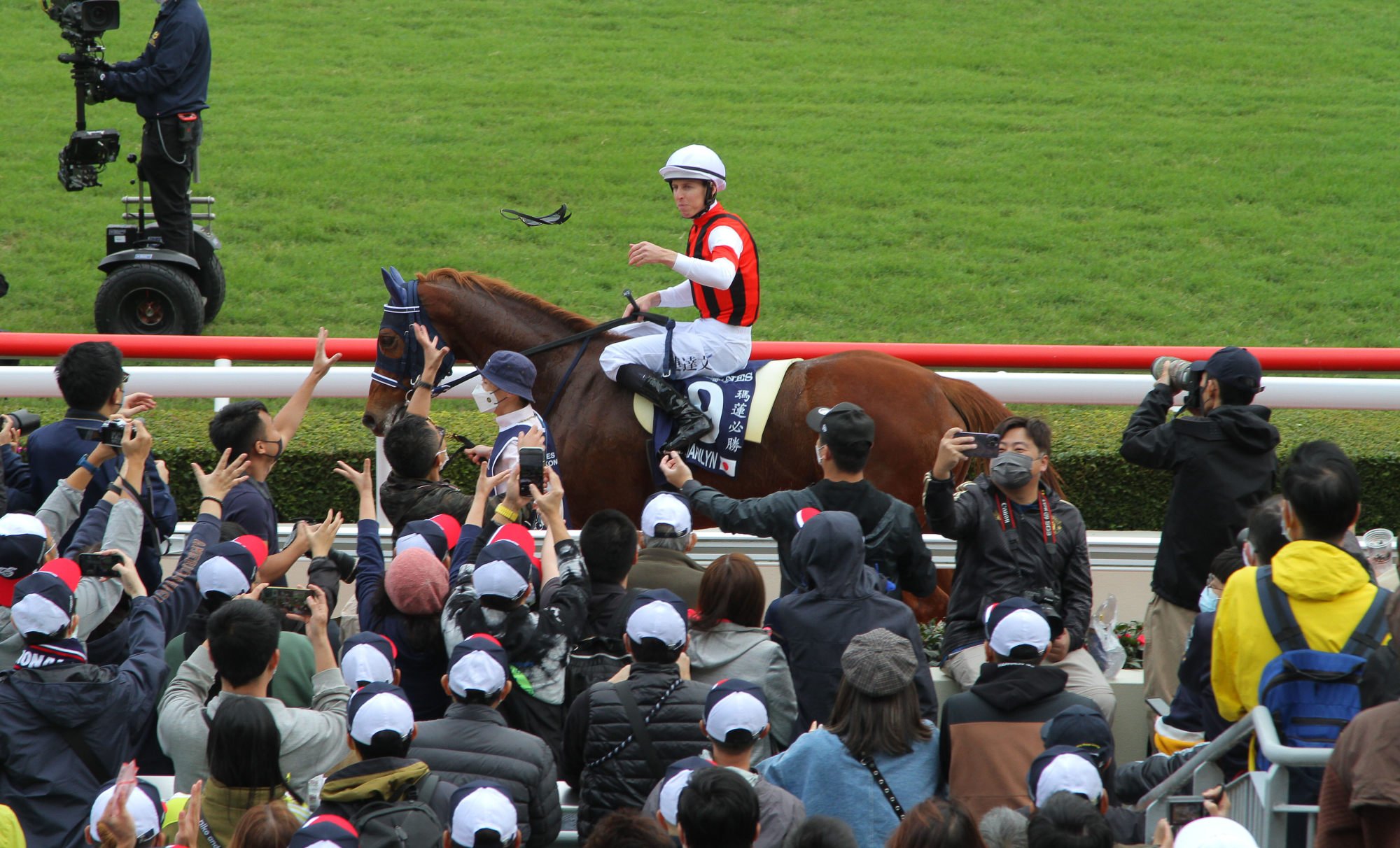 Damian Lane throws his goggles to the crowd.