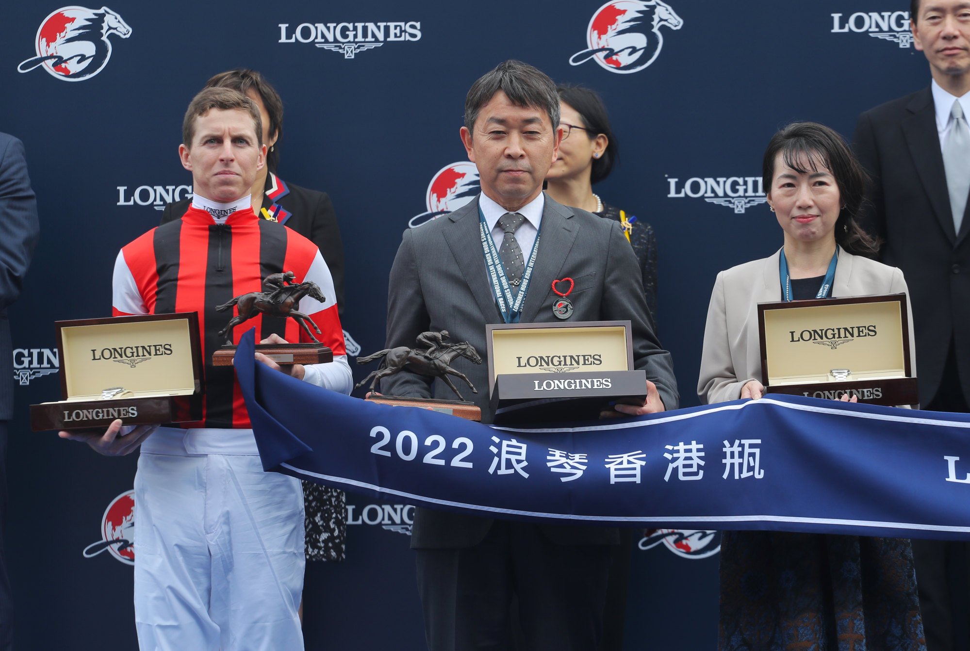 Jockey Damian Lane and trainer Takahisa Tezuka receive their spoils.