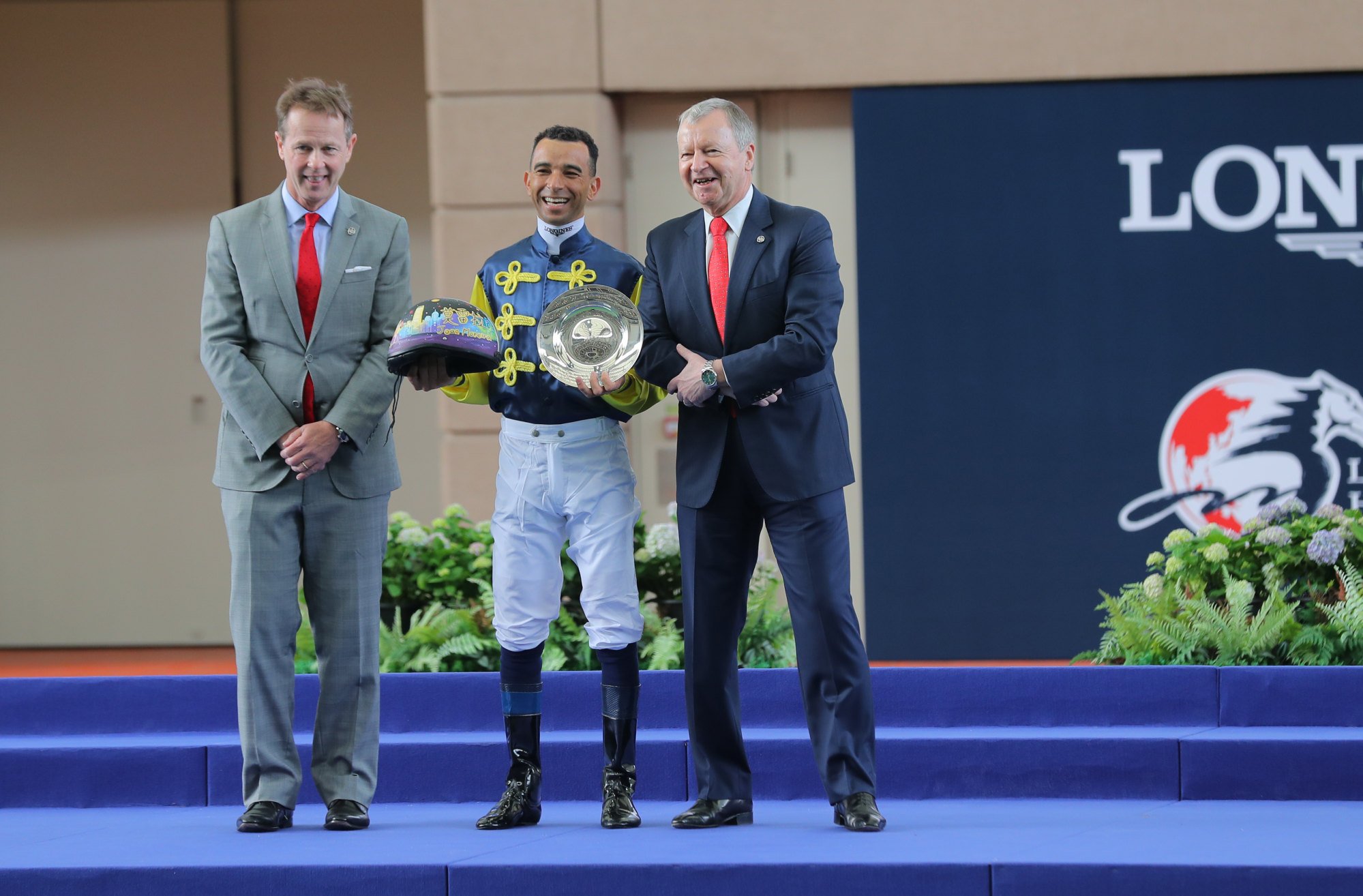 Jockey Club officials Andrew Harding (left) and Winfried Engelbrecht-Bresges farewell star jockey Joao Moreira.