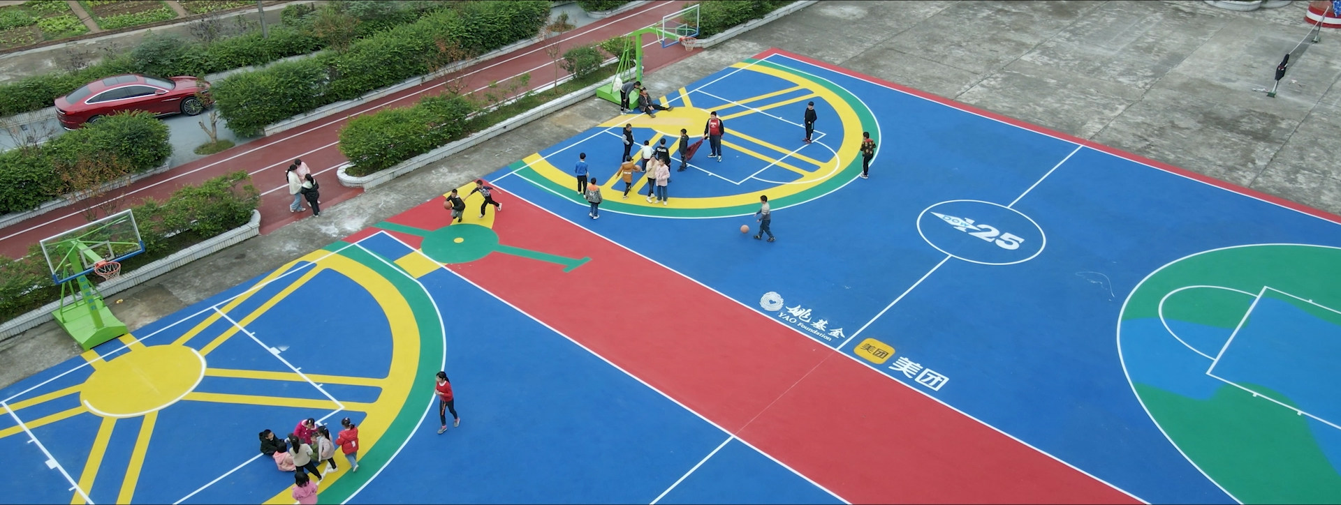 Children play on one of the colourful sport grounds built using upcycled old tyres in rural China. 