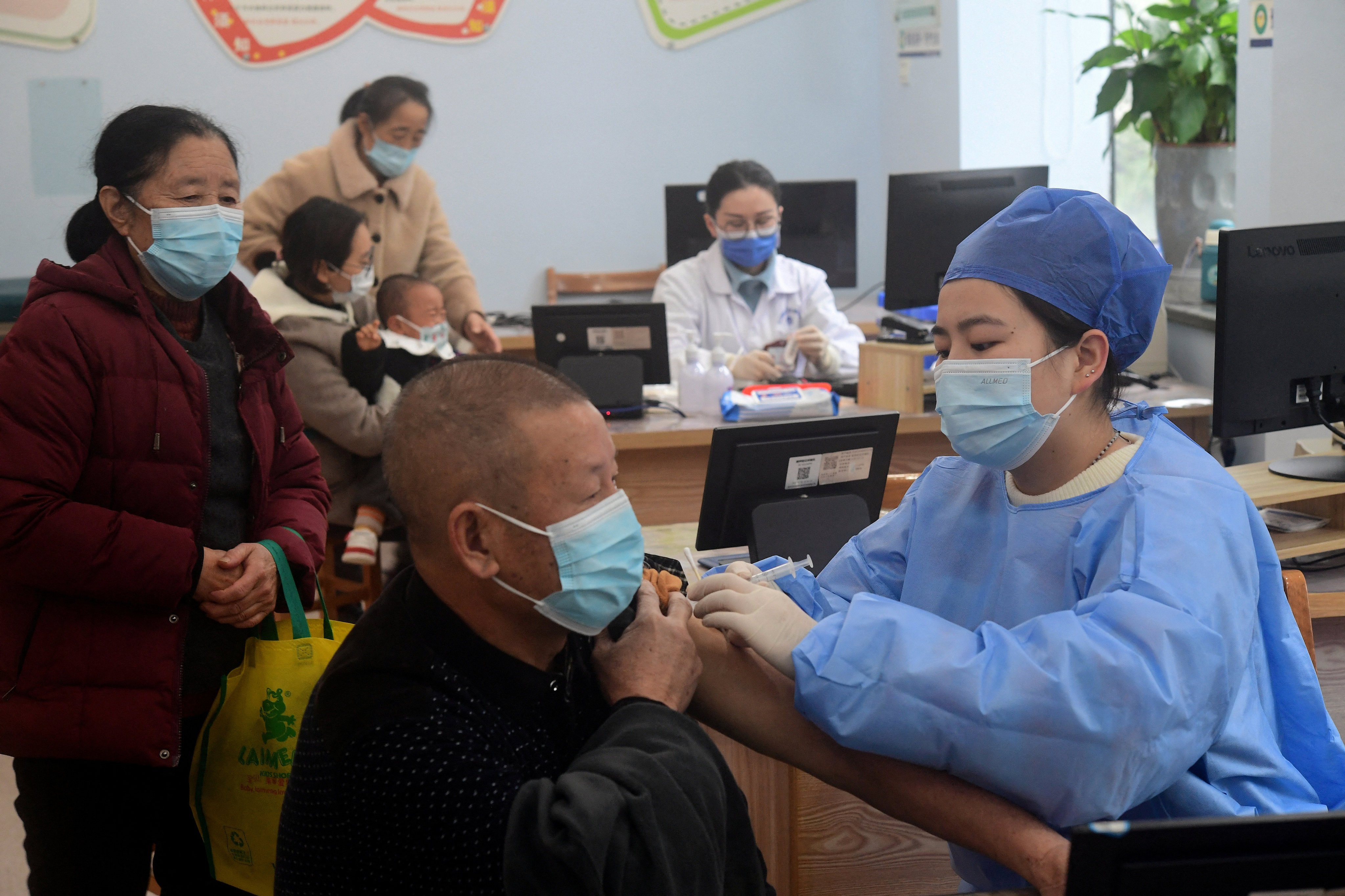 A medical worker administers a dose of the Covid-19 vaccine to an elderly resident at a community health service centre in Jinhua, Zhejiang province, on December 5. China’s vaccine drive has been hampered by the lack of a vaccine mandate. Photo: China Daily via Reuters 
