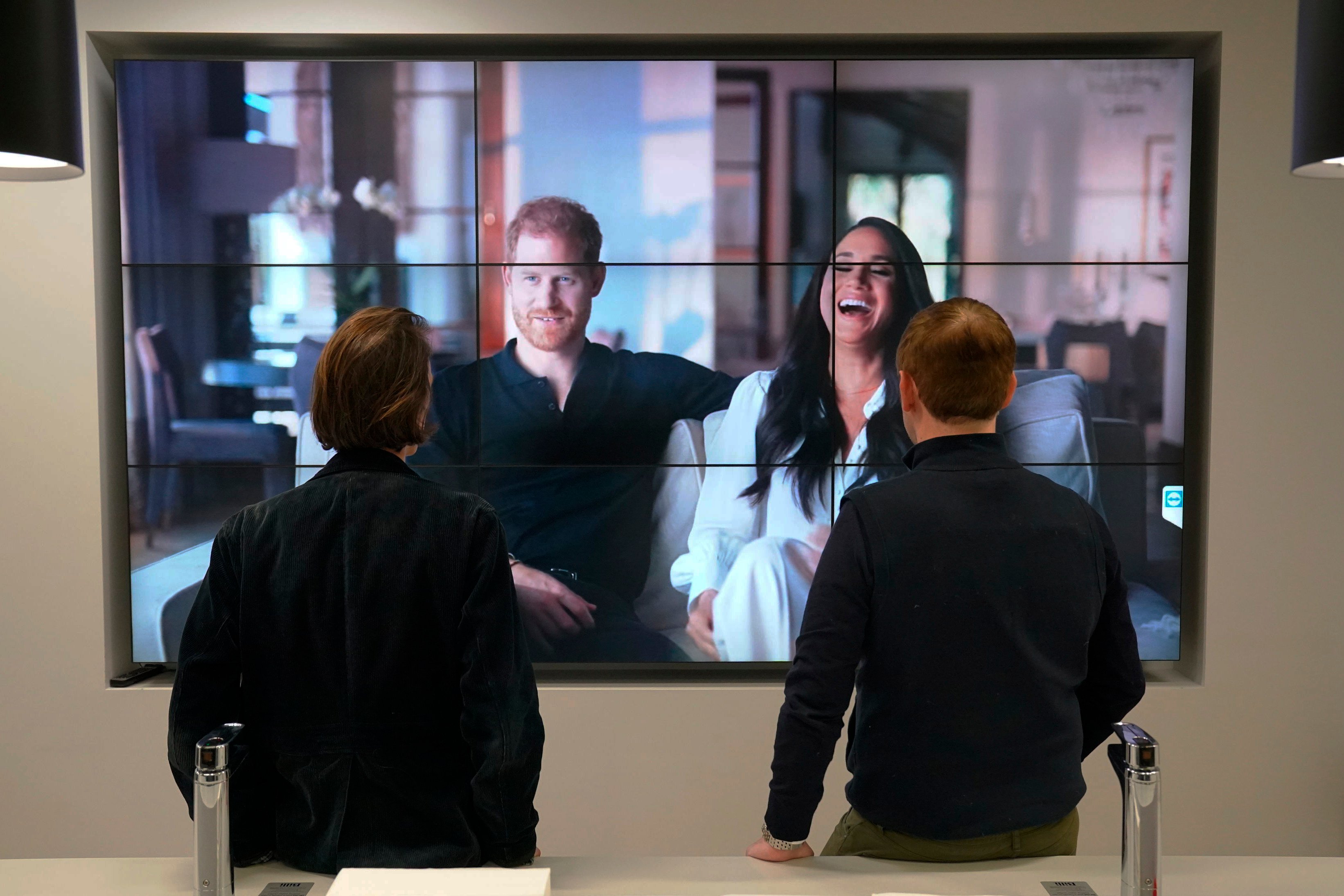 Office workers in London watch Prince Harry and Meghan Markle, the Duke and Duchess of Sussex’s controversial documentary being aired on Netflix, on December 8. Photo: AP