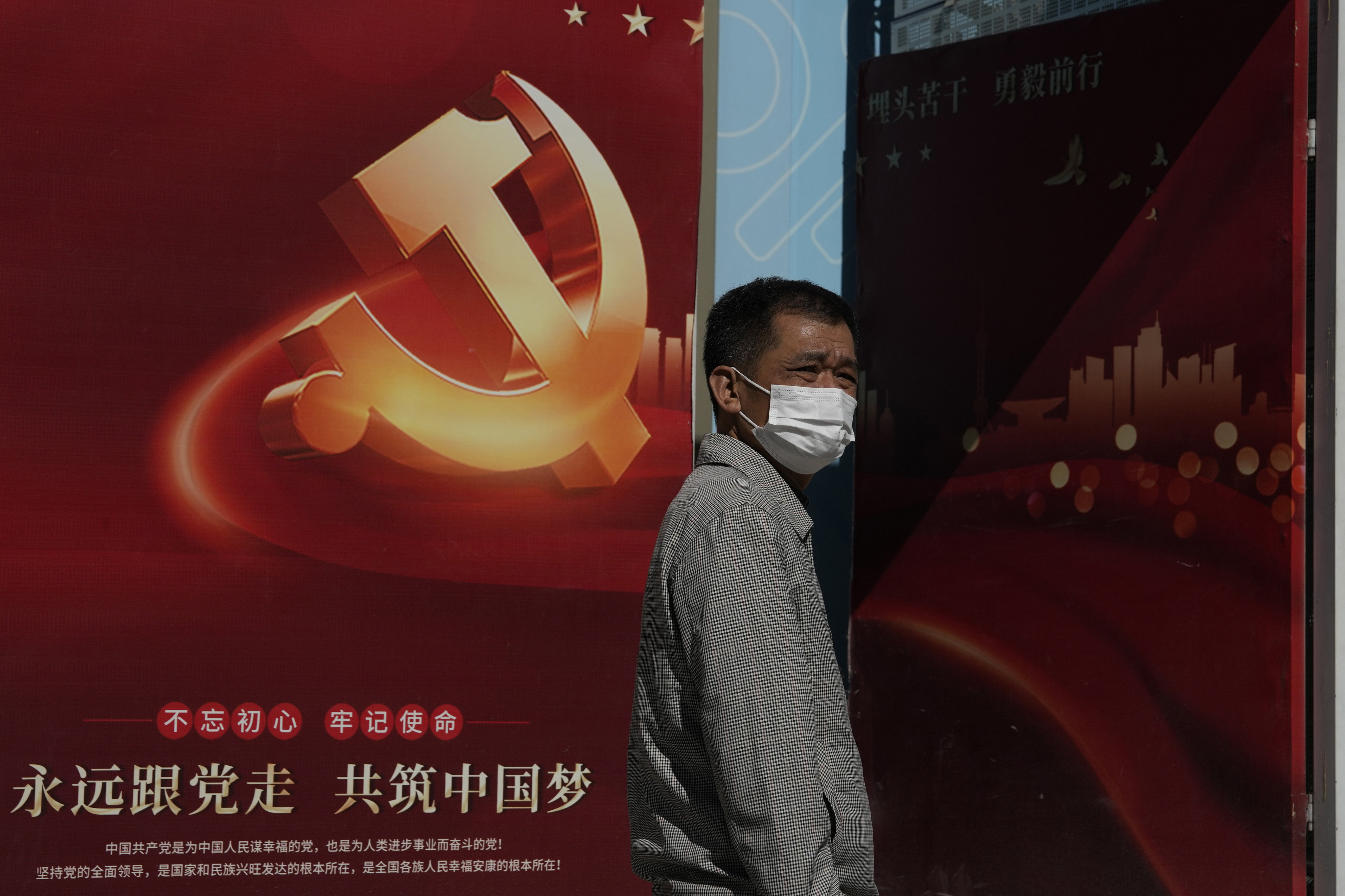 A man passes by a sign for the 20th party congress with the words “Forever follow the party, jointly build the Chinese dream” in Beijing on October 10. President Xi Jinping has called for the “great rejuvenation of the Chinese nation” based on reviving the ruling party’s role as an economic, social and cultural leader. Photo: AP