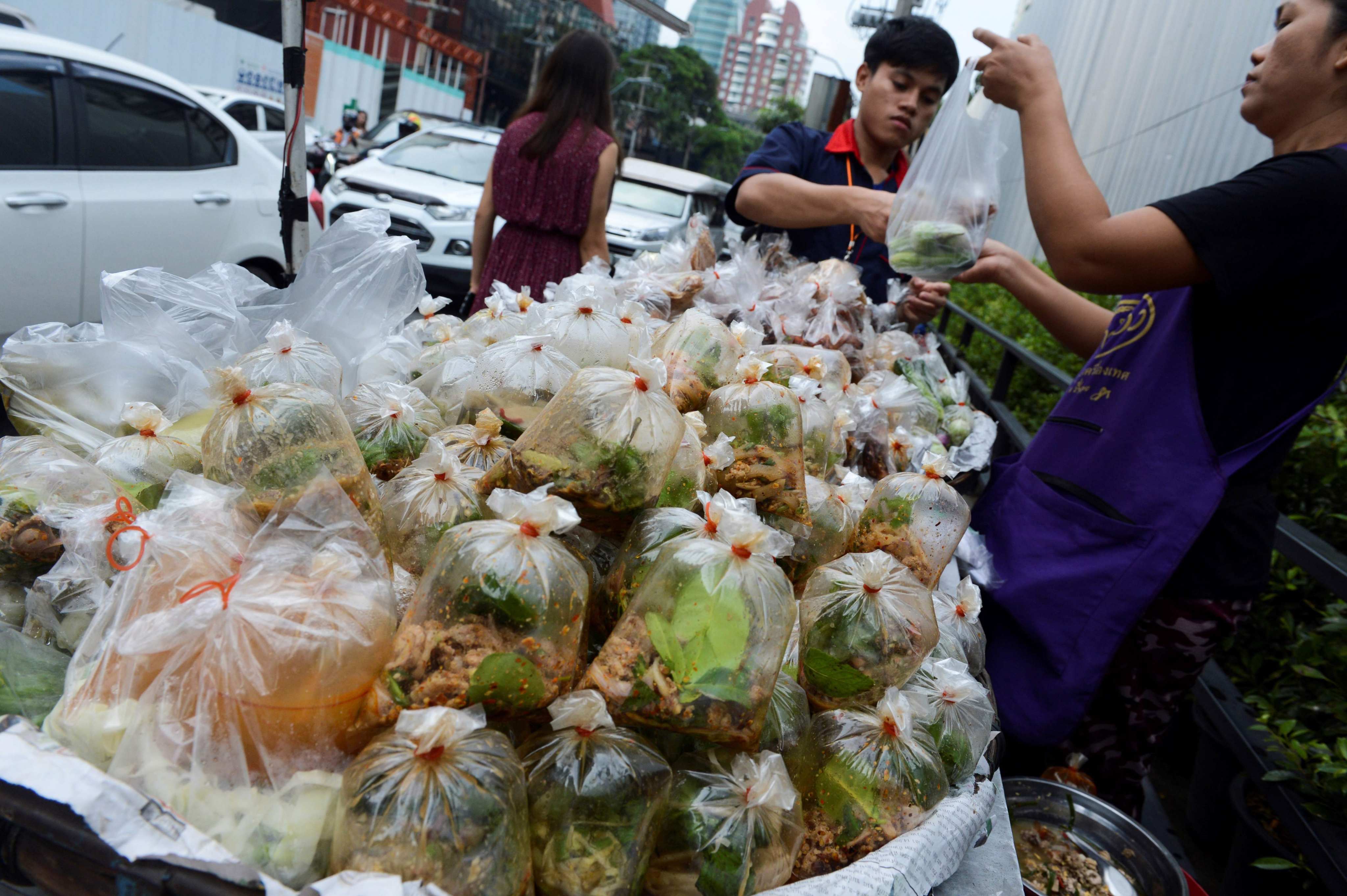 A vendor sells food packed in plastic bags in Bangkok in June 2018. Photo: AFP