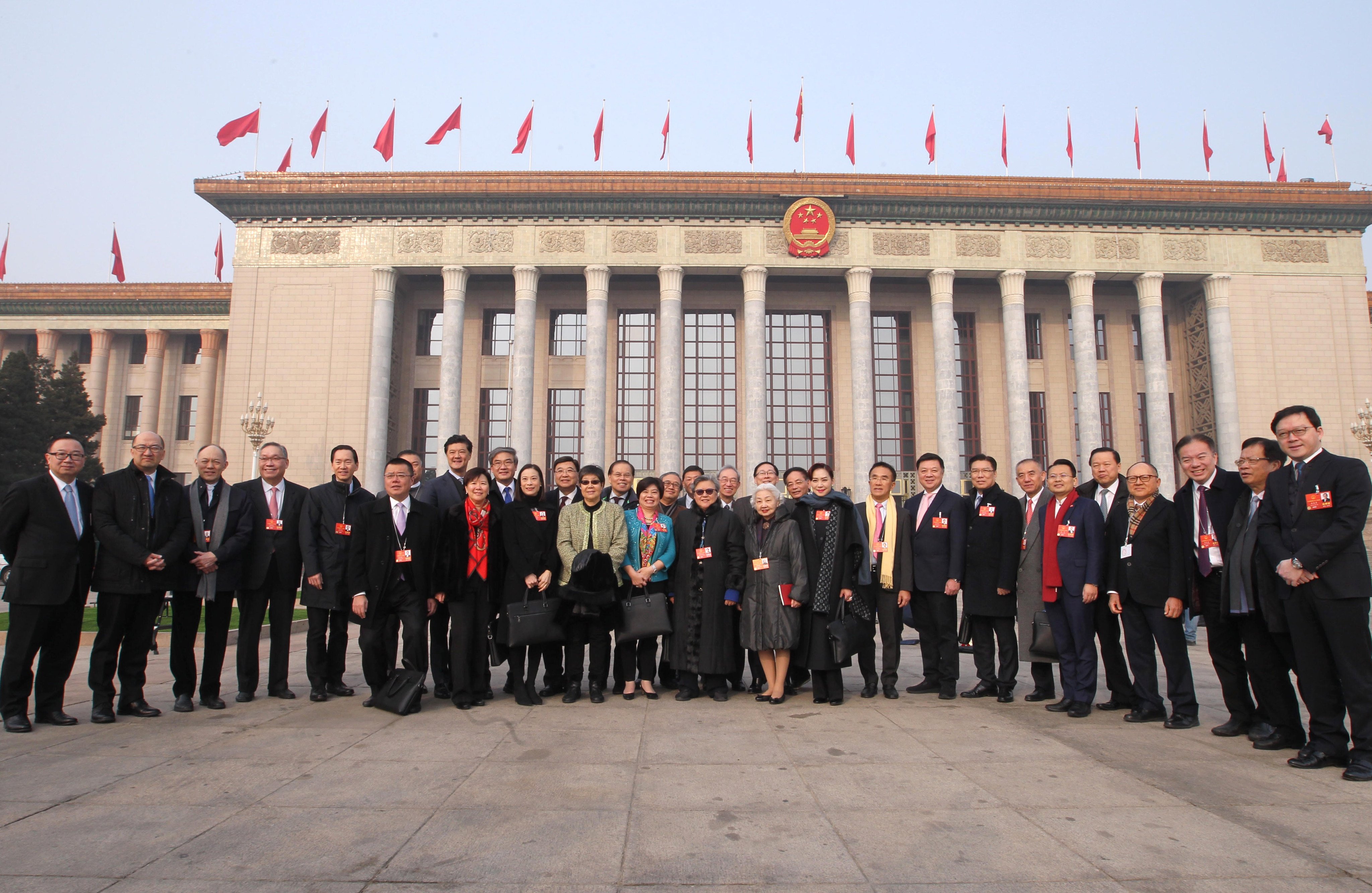 Hong Kong delegates to the NPC pose for a group photo before a session of the NPC meeting at the Great Hall of the People in Beijing, on March 13, 2018. Photo: Simon Song