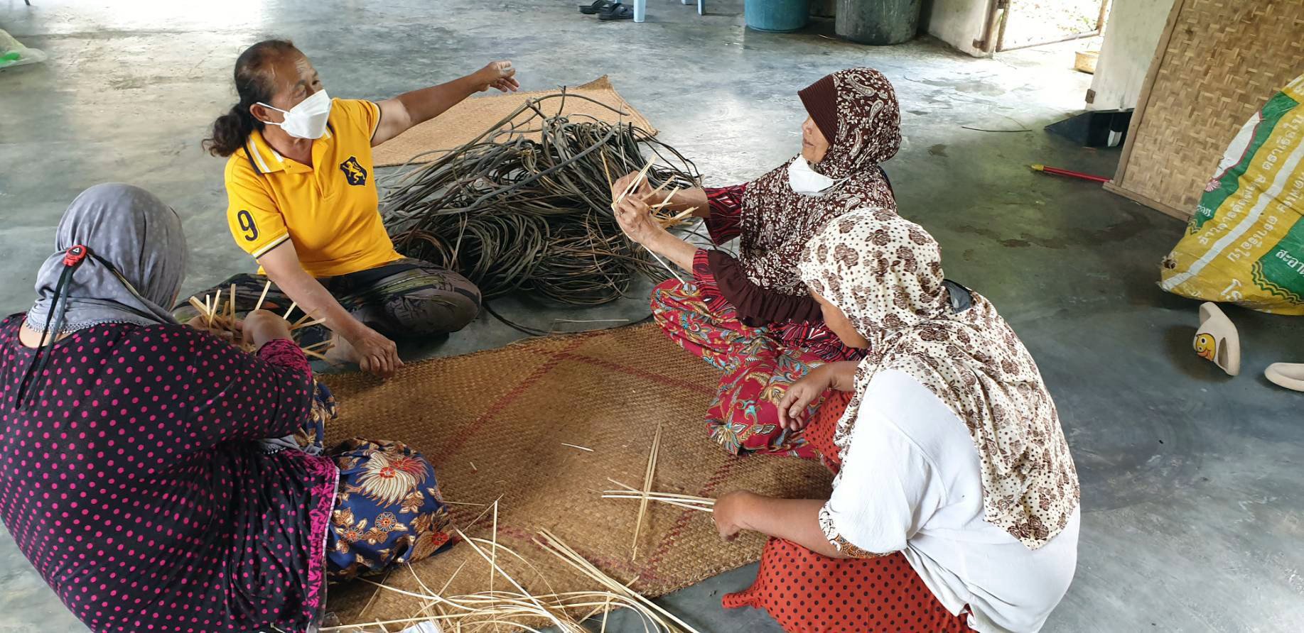 Sompong Ad-Inmong (second from left) teaches bamboo weaving to conflict-affected women in Pattani province. Photo: Handout
