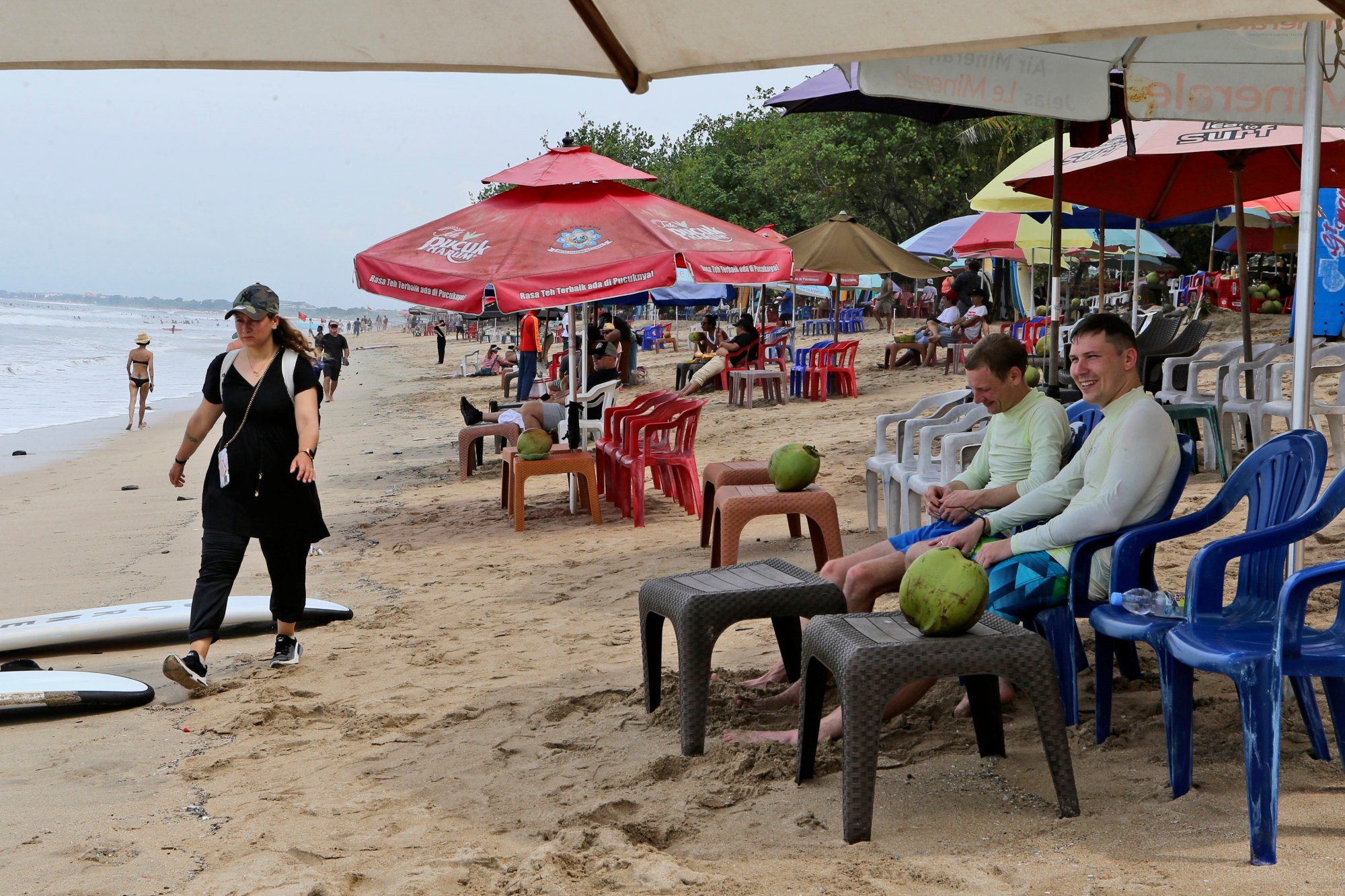 Foreign tourists sit on a beach in Bali. Uncertainty over Indonesia’s new second home visa has left some foreign retirees and pensioners pondering their next move. Photo: AP