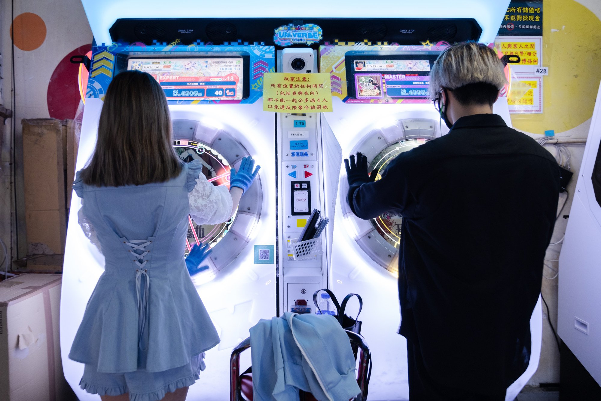 Two gamers play “Maimai DX Universe Plus” together at an arcade in Mong Kok. Photo: Connor Mycroft