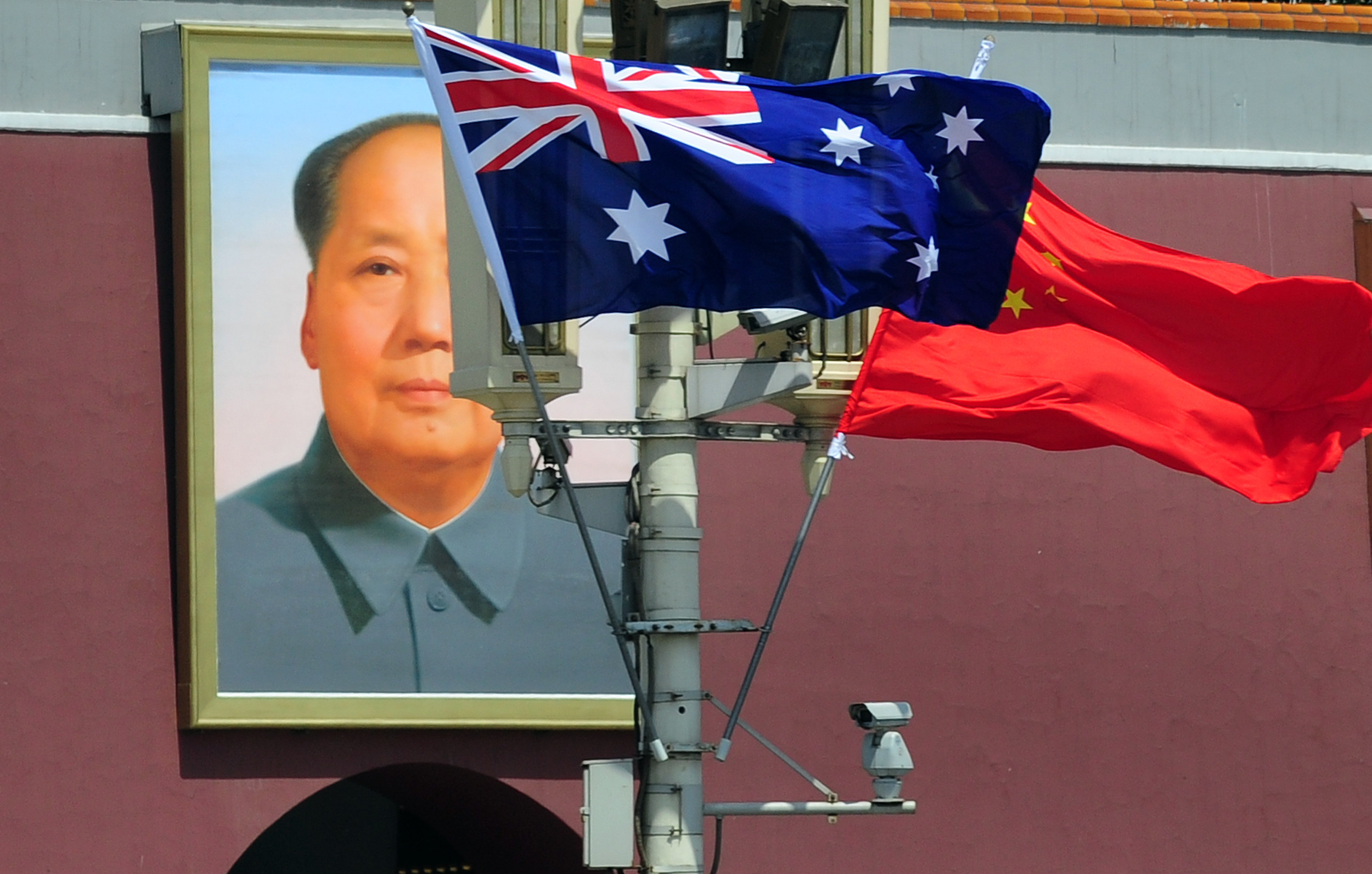 The national flags of Australia and China are displayed before a portrait of Mao Zedong facing Tiananmen Square, during a visit by Australia’s Prime Minister Julia Gillard in Beijing on April 26, 2011. Photo: AFP via Getty Images