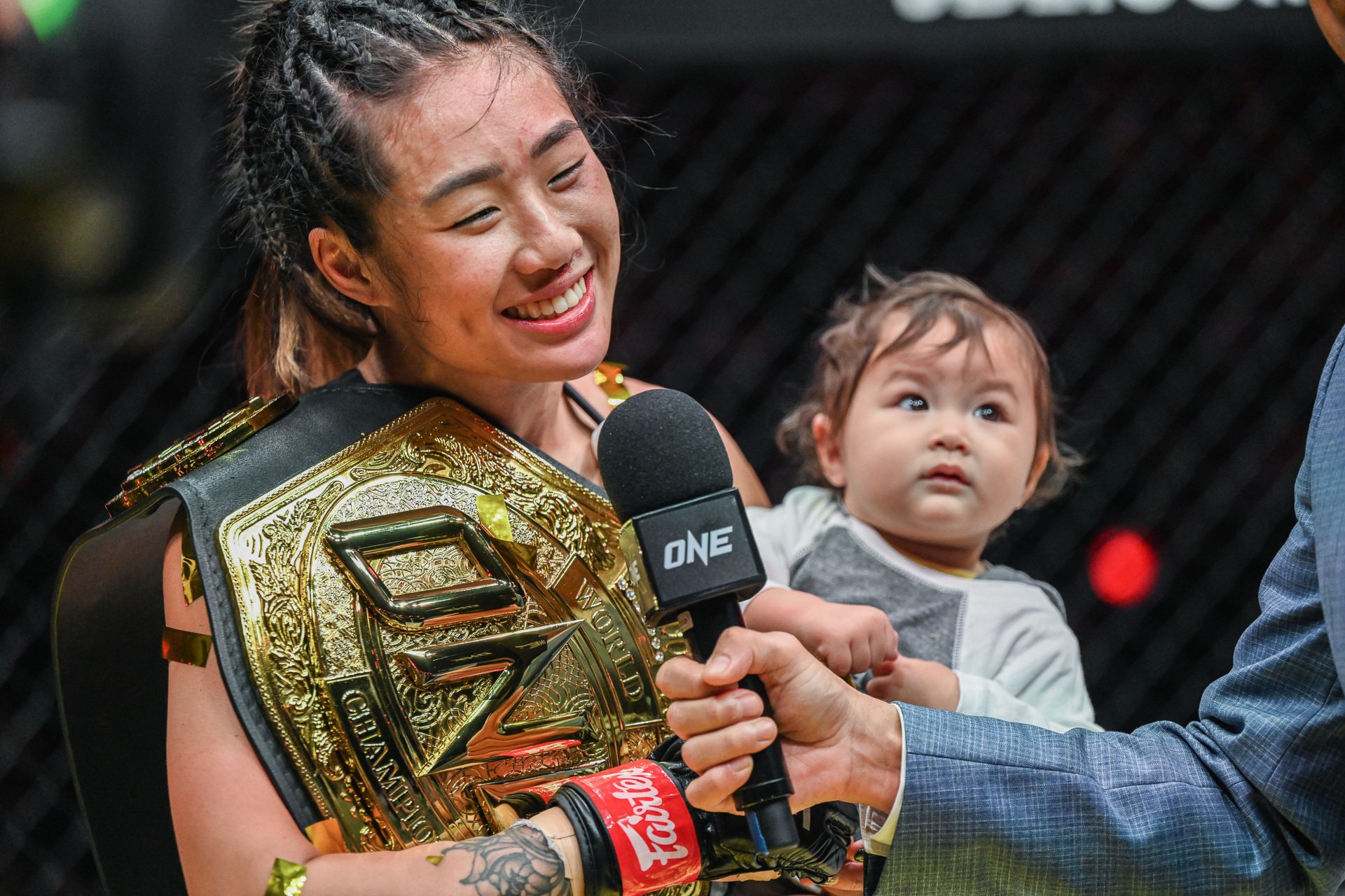 Angela Lee with her baby daughter in the cage after her victory at ONE X. Photos: ONE Championship. 