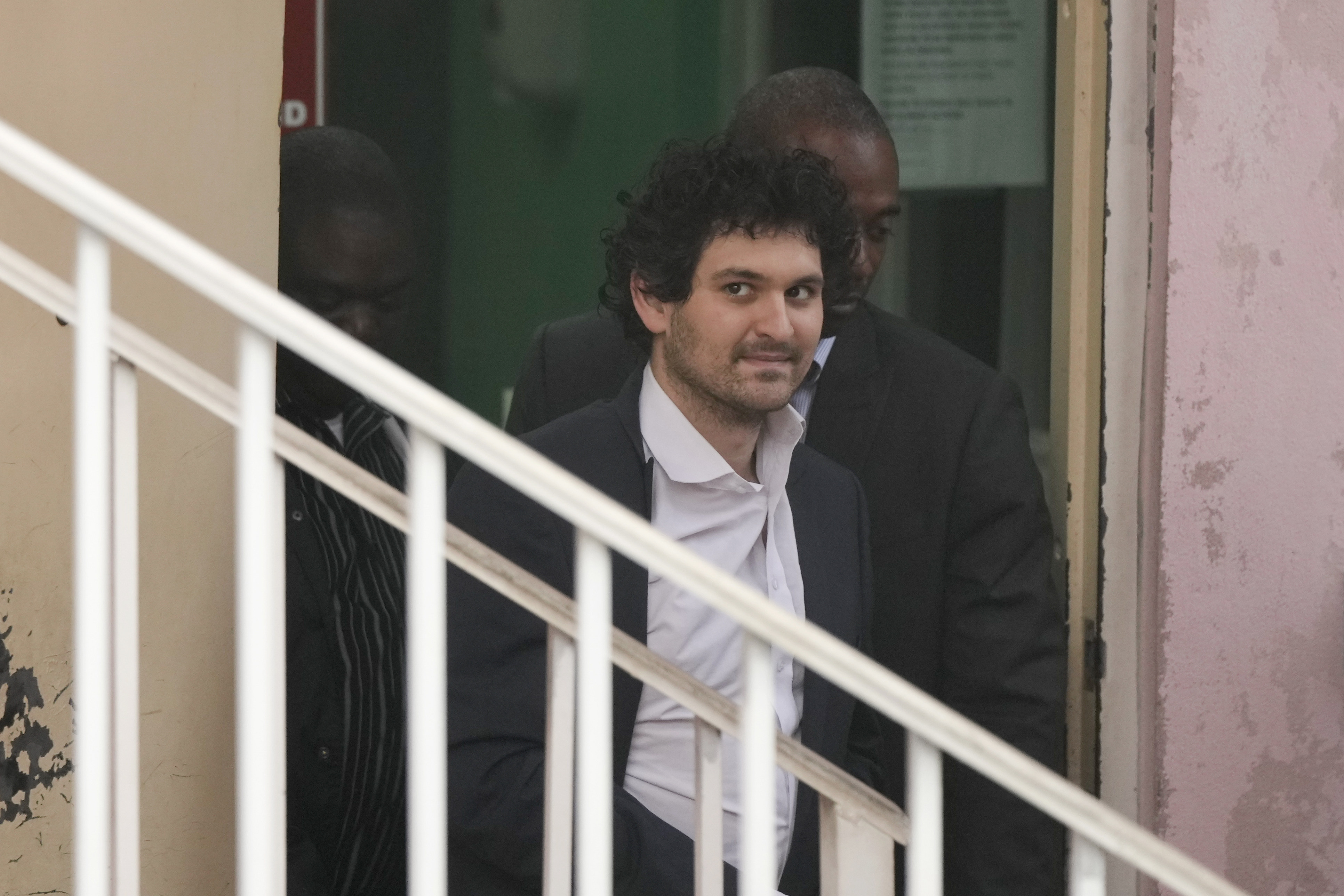 FTX founder Sam Bankman-Fried, being escorted from the Magistrate Court in Nassau, Bahamas. Photo: AP