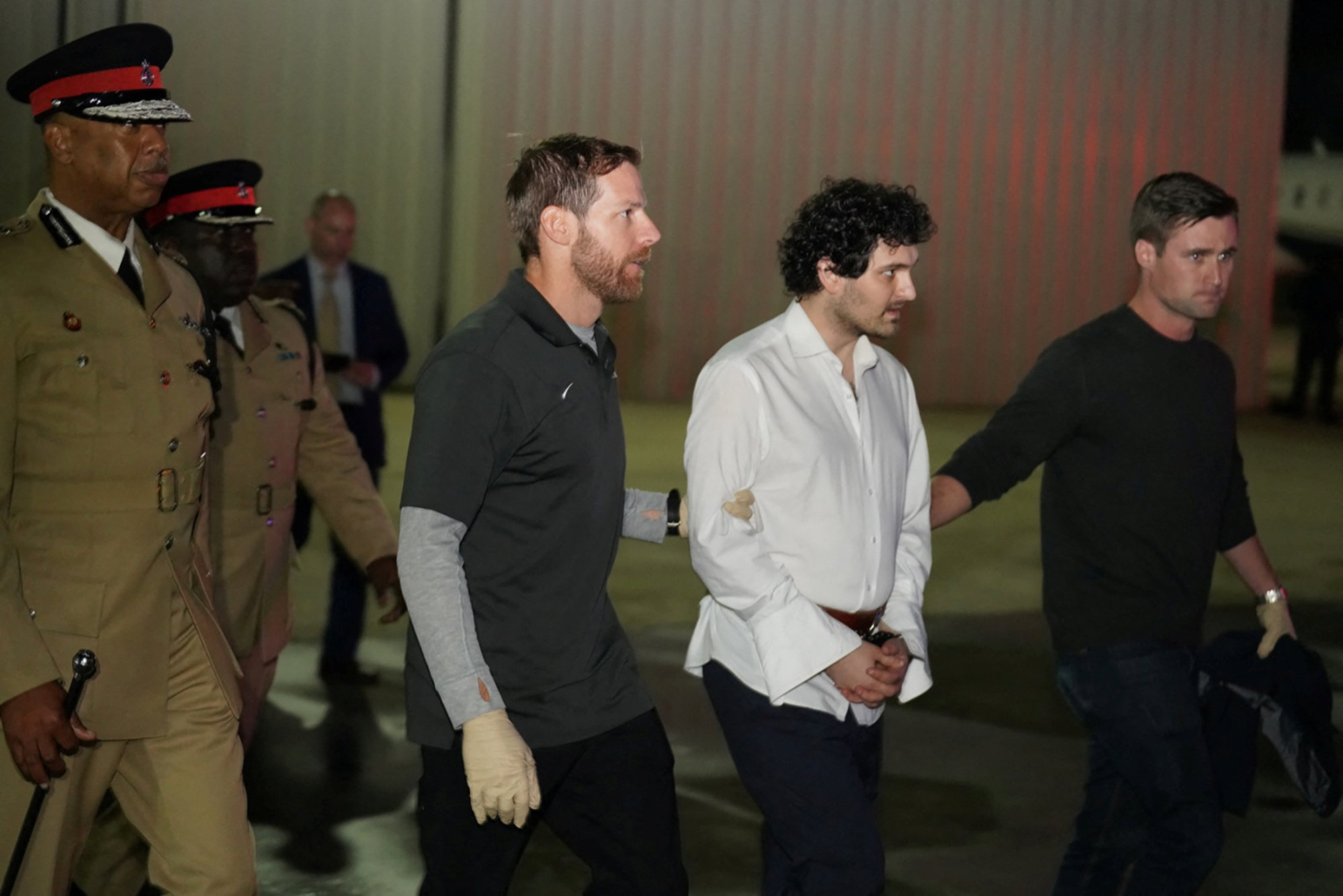 Sam Bankman-Fried, founder and former CEO of cryptocurrency exchange FTX, is taken to a plane during his extradition to the United States from Nassau, Bahamas on Wednesday. Photo: Handout via Reuters