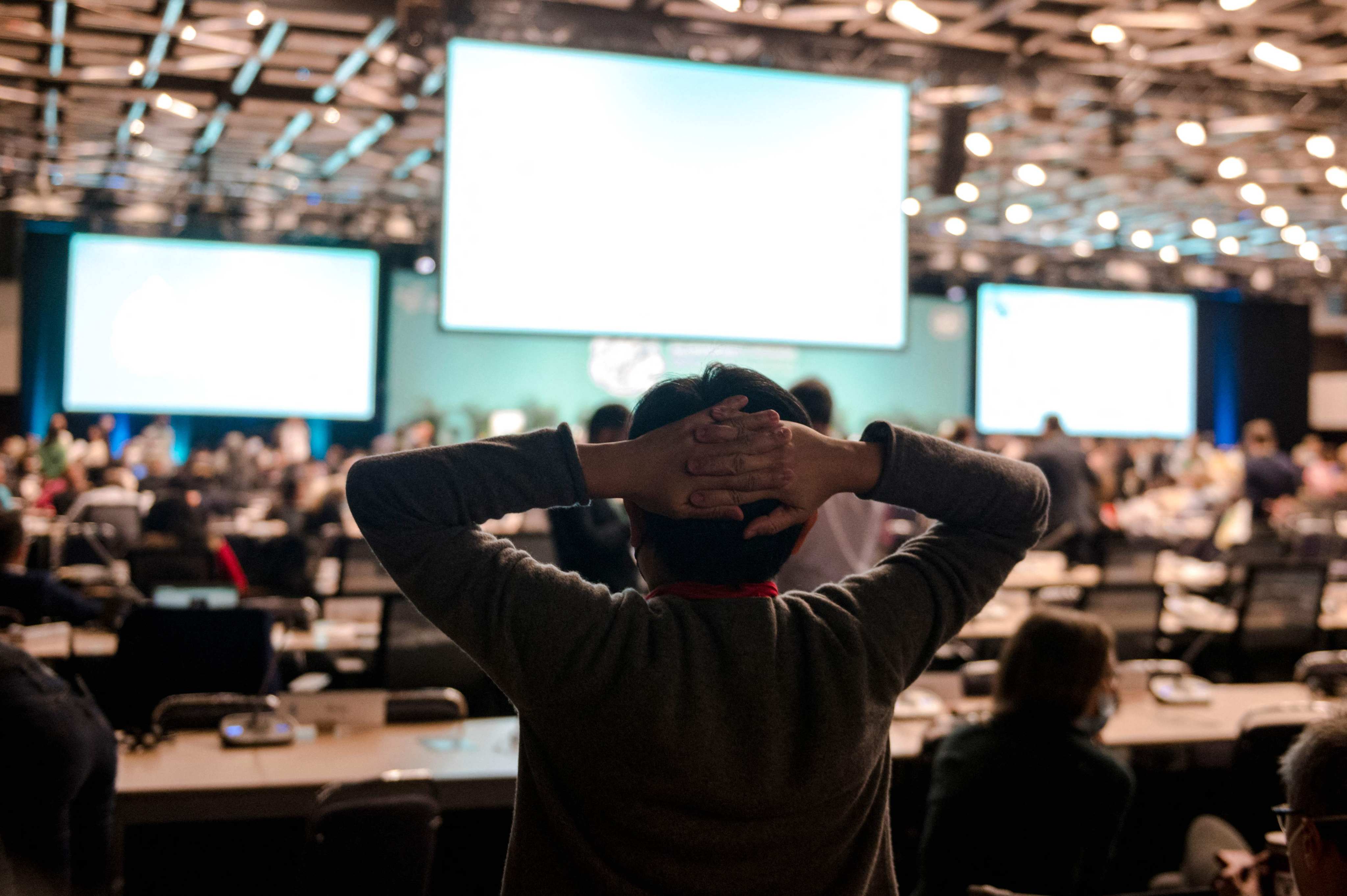 A delegate stretches before a plenary at the tail end of the United Nations Biodiversity Conference in Montreal, Quebec, Canada, on December 18. Photo: AFP