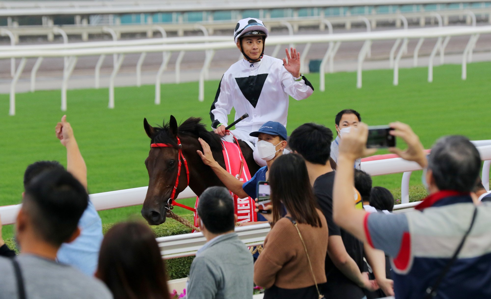 Derek Leung receives the applause of the Sha Tin crowd after winning the Chevalier Cup aboard Keefy last month.