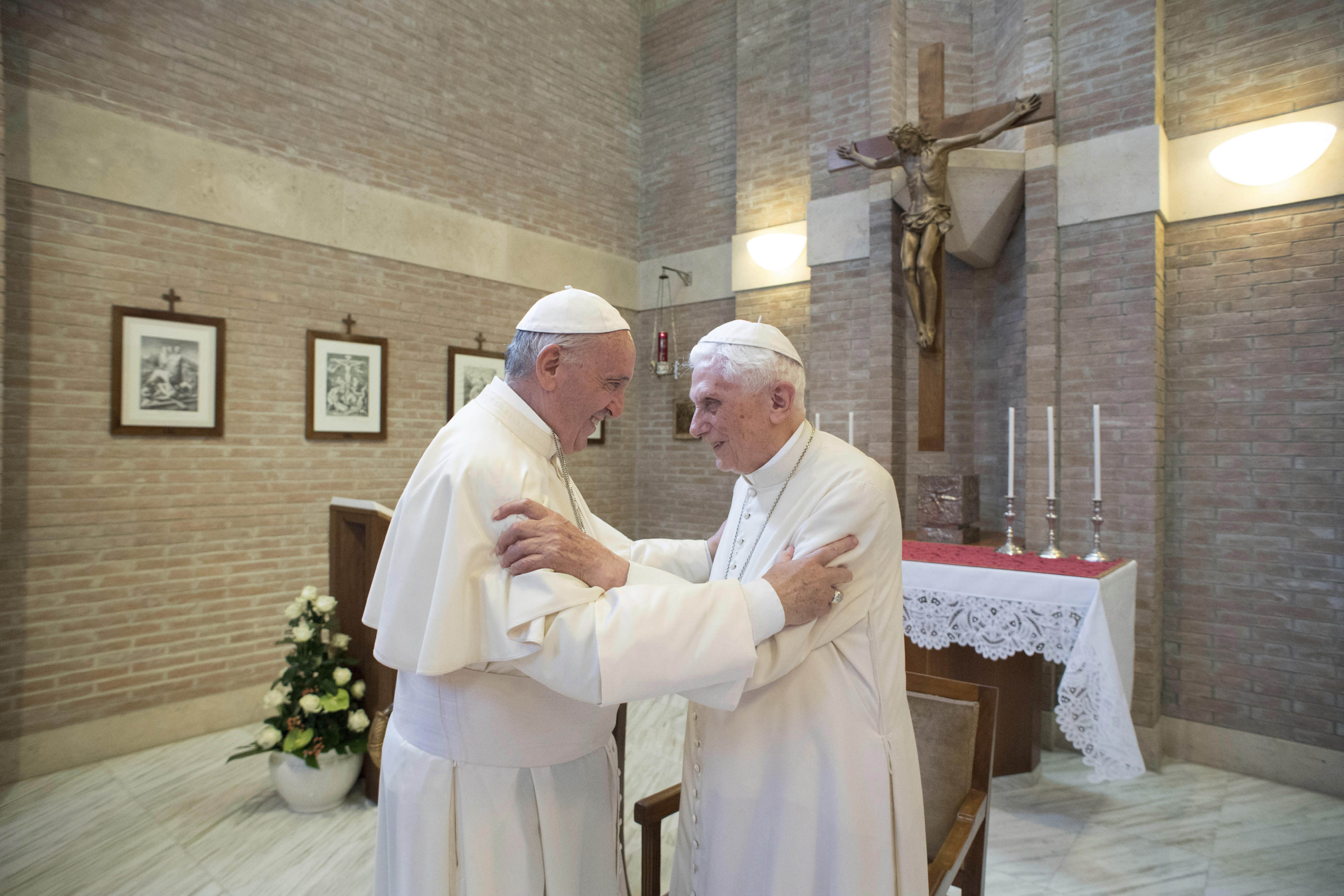 Pope Francis, left, embraces Emeritus Pope Benedict XVI, at the Vatican. Photo: AP