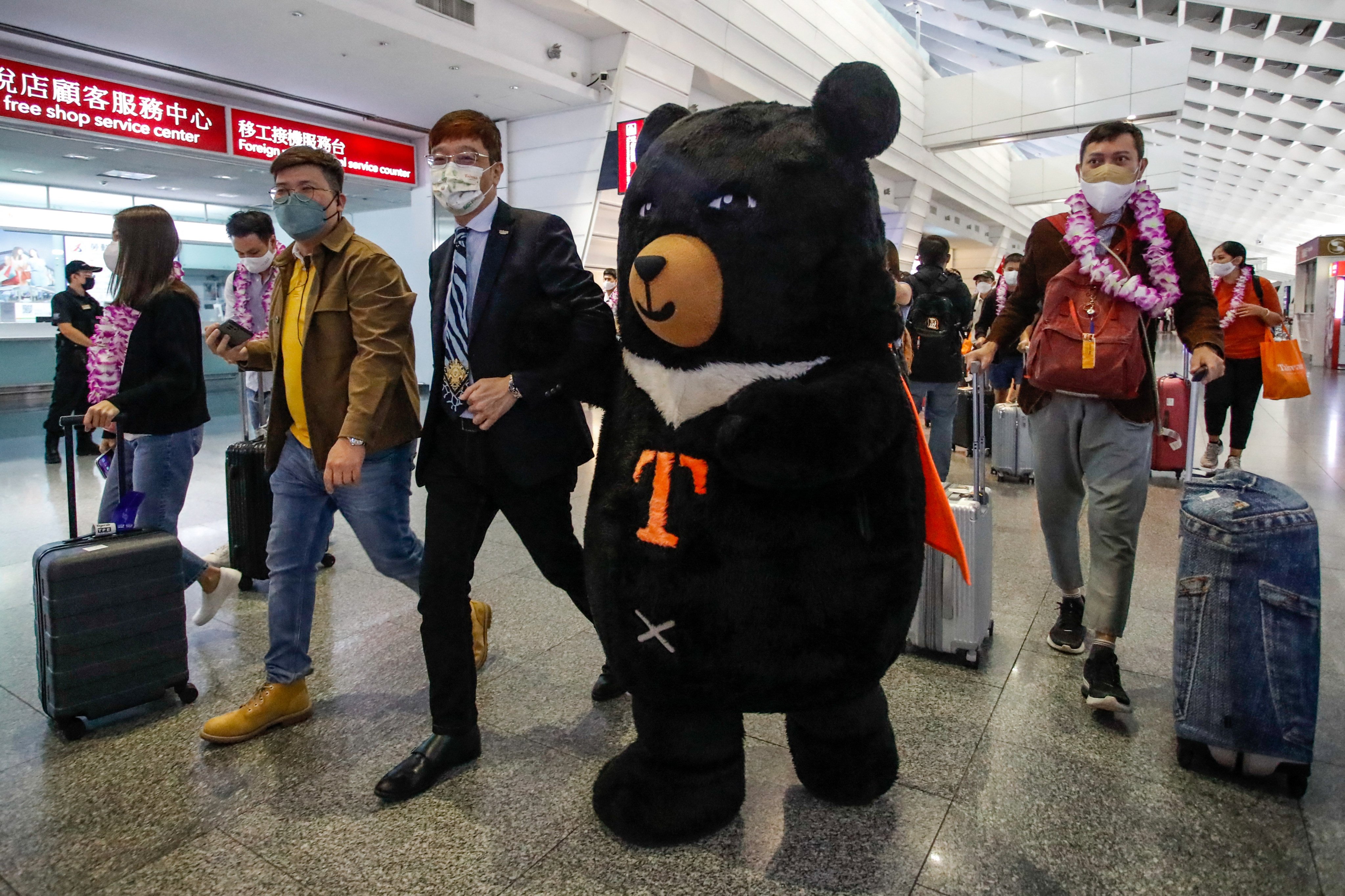 A mascot welcomes the first overseas arrivals at Taoyuan International Airport in October after Taiwan reopened its borders by ending mandatory Covid-19 quarantine for arrivals. Photo:  AFP