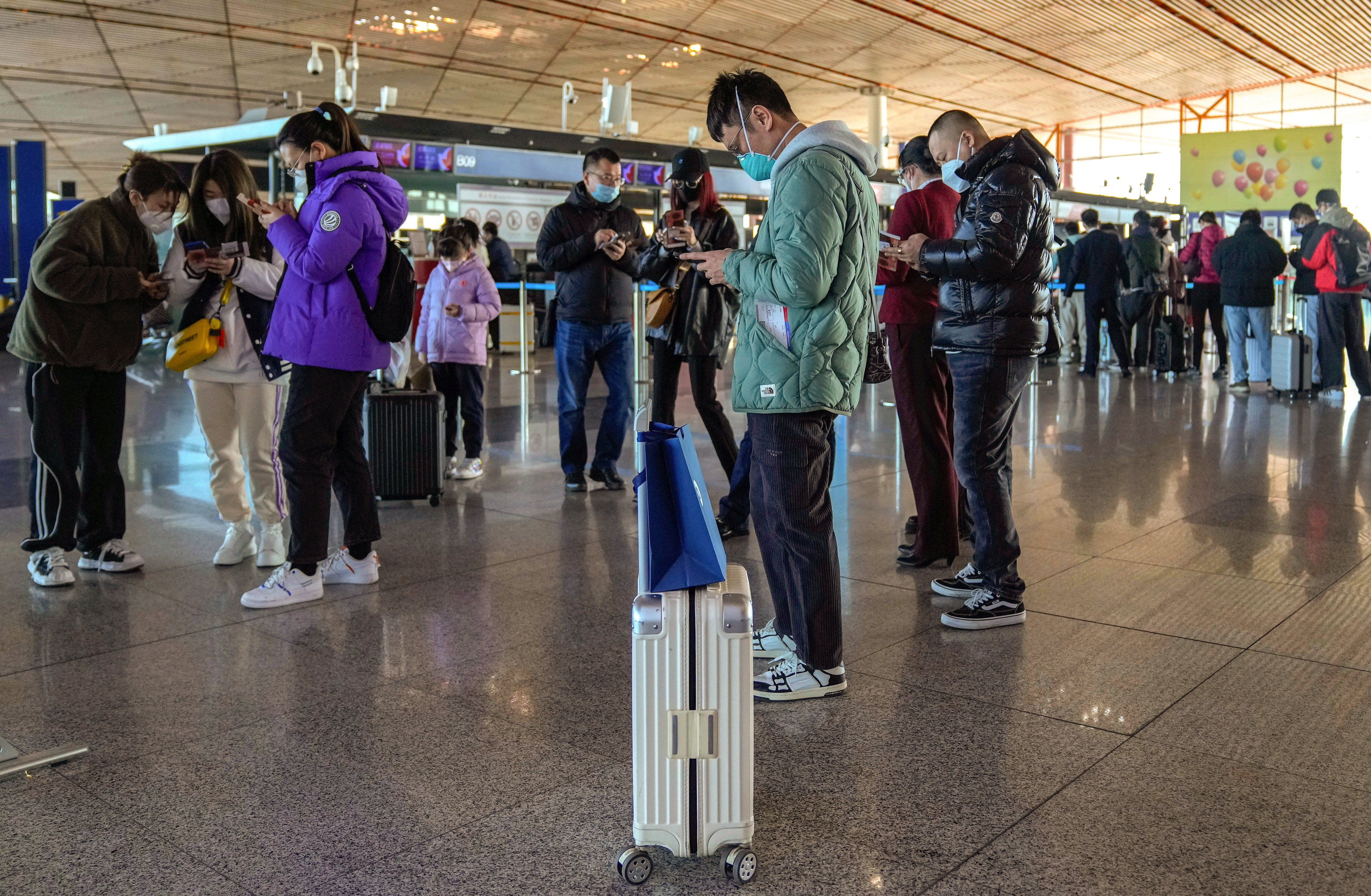 China has announced that it will lift restrictions on travel overseas next month. Photo: AP