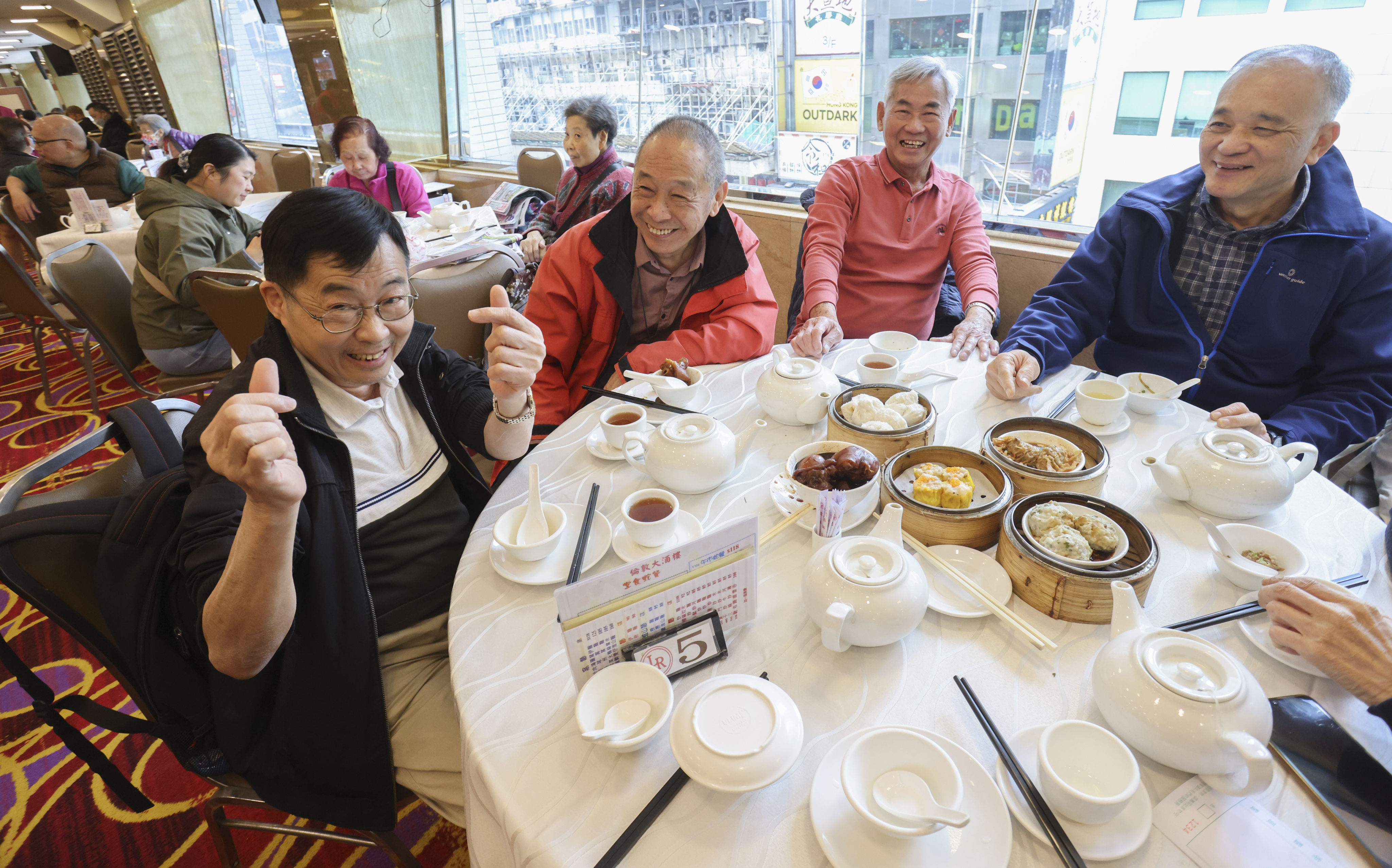 Cheng Kai-cheung (left) says he feels more comfortable asking friends out for dim sum after restrictions were cut. Photo: May Tse