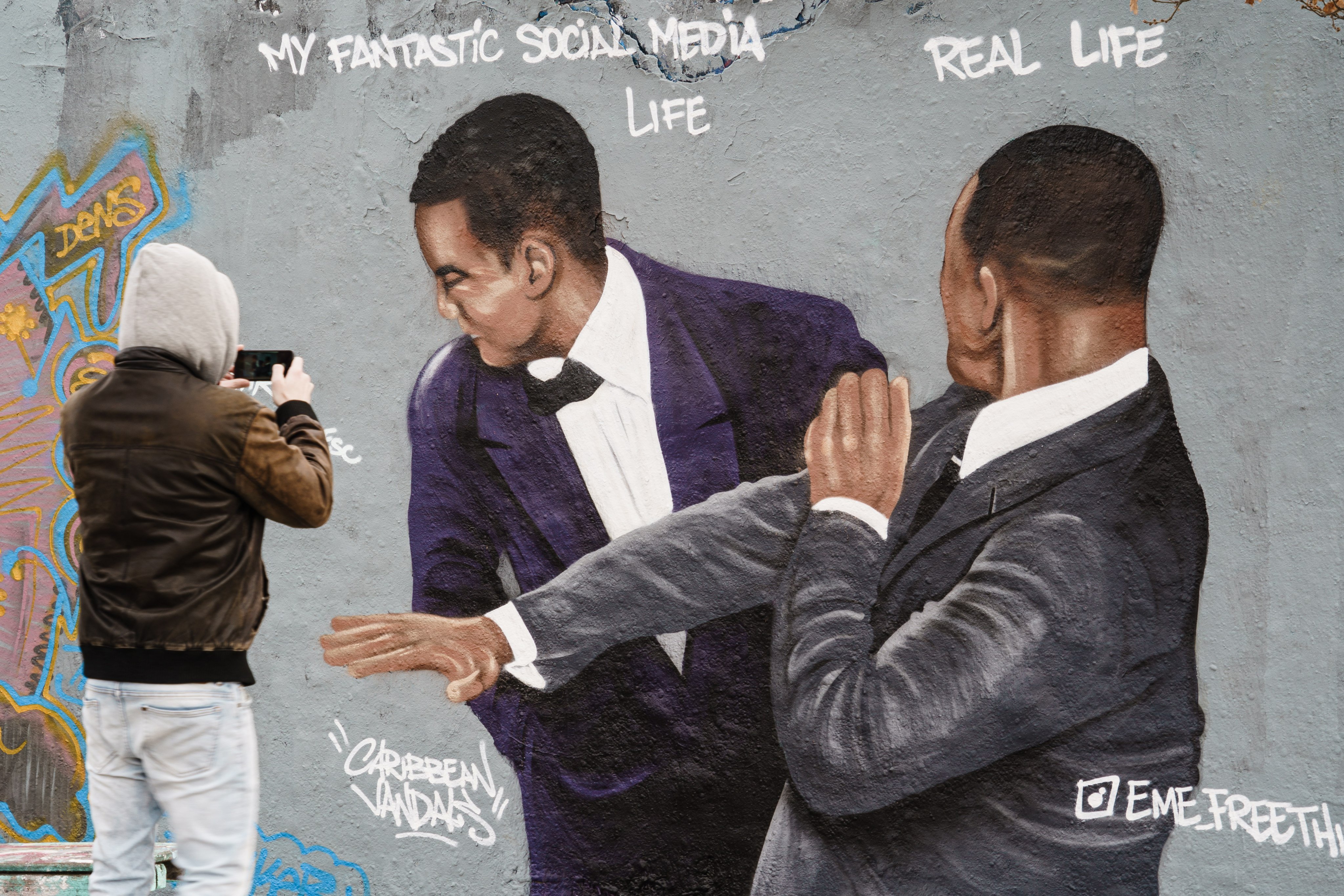 Remember THAT moment Will Smith smacked Chris Rock at the Oscars? Picutred is a graffiti mural showing the scene that took place at the Academy Awards. What other pop moments have you missed from 2022? Photo: EPA