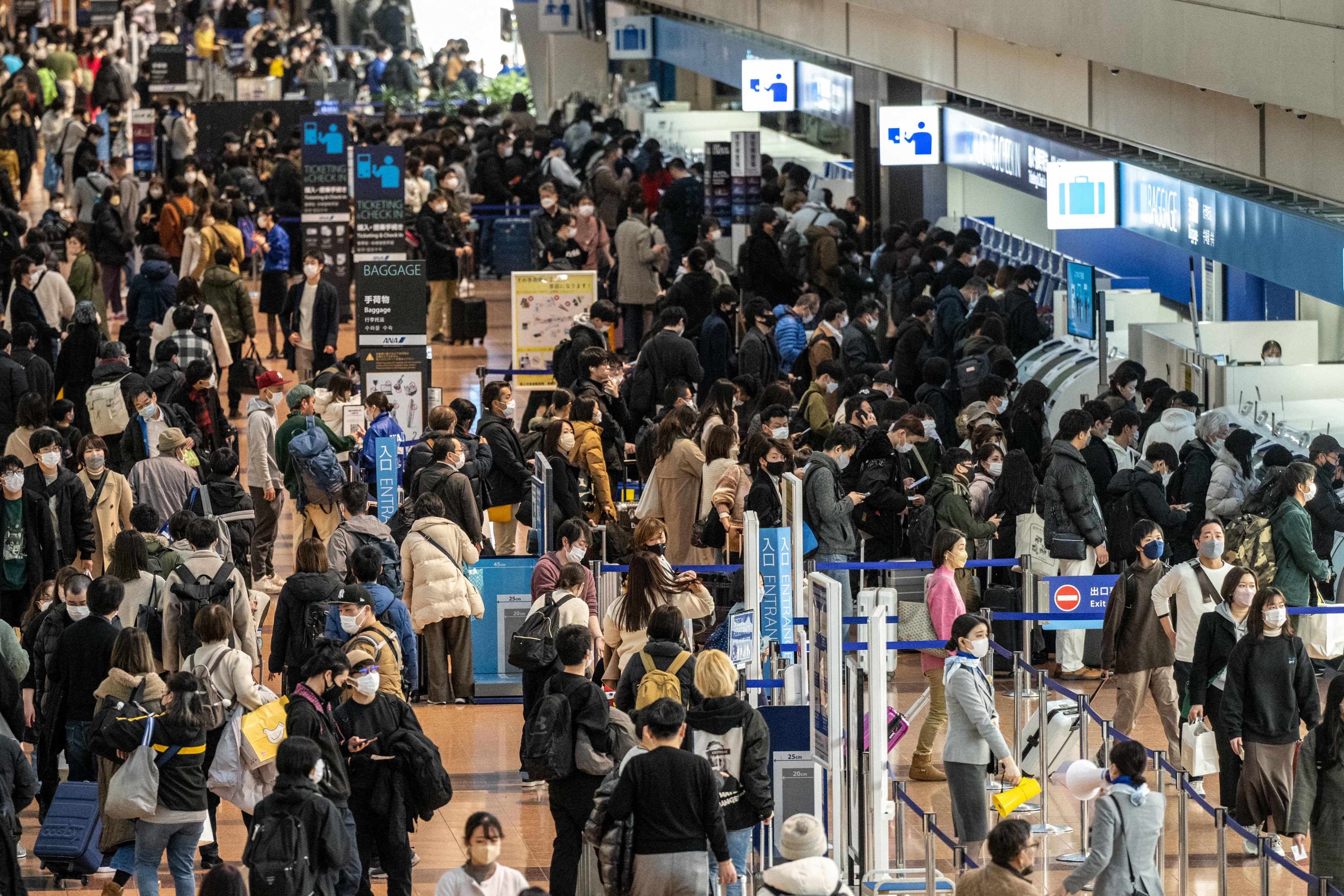 Travellers at Tokyo’s Haneda airport. Photo: AFP