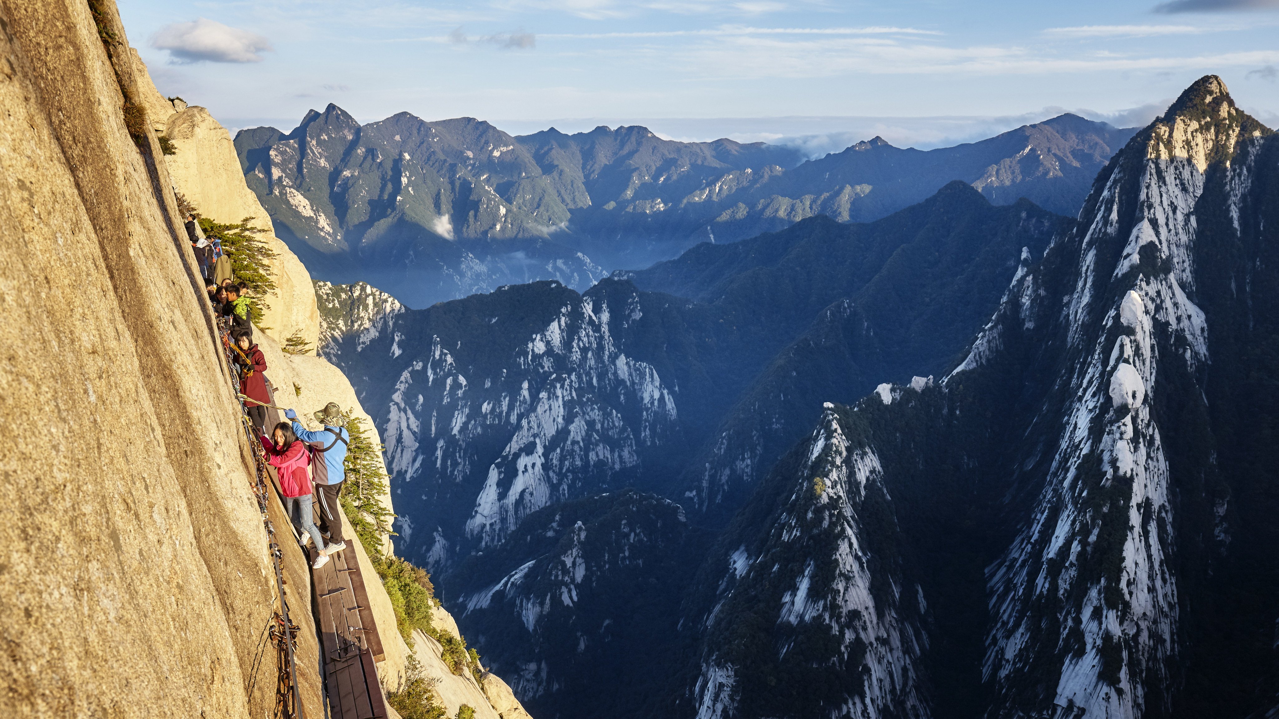 Tourists take on the “plank walk”, among the world’s most dangerous trails. Photo: Shutterstock Images