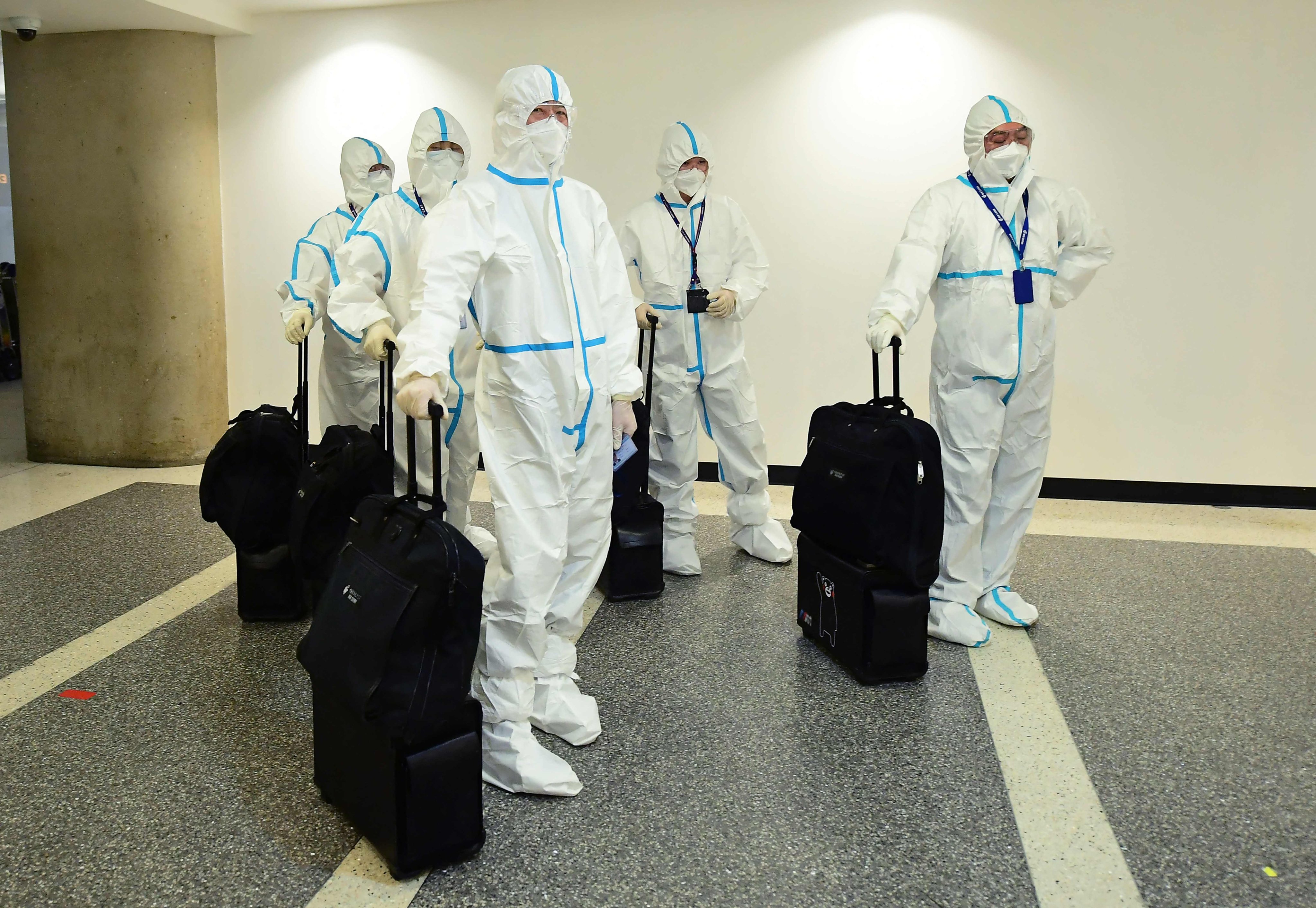 In this file photo taken on December 3, 2021, the flight crew from Air China arrive in hazmat suits in the international terminal at Los Angeles International Airport. The US will require negative Covid tests from all air travelers from China, saying Beijing is not sharing enough information about the surge in coronavirus cases there. Photo: AFP