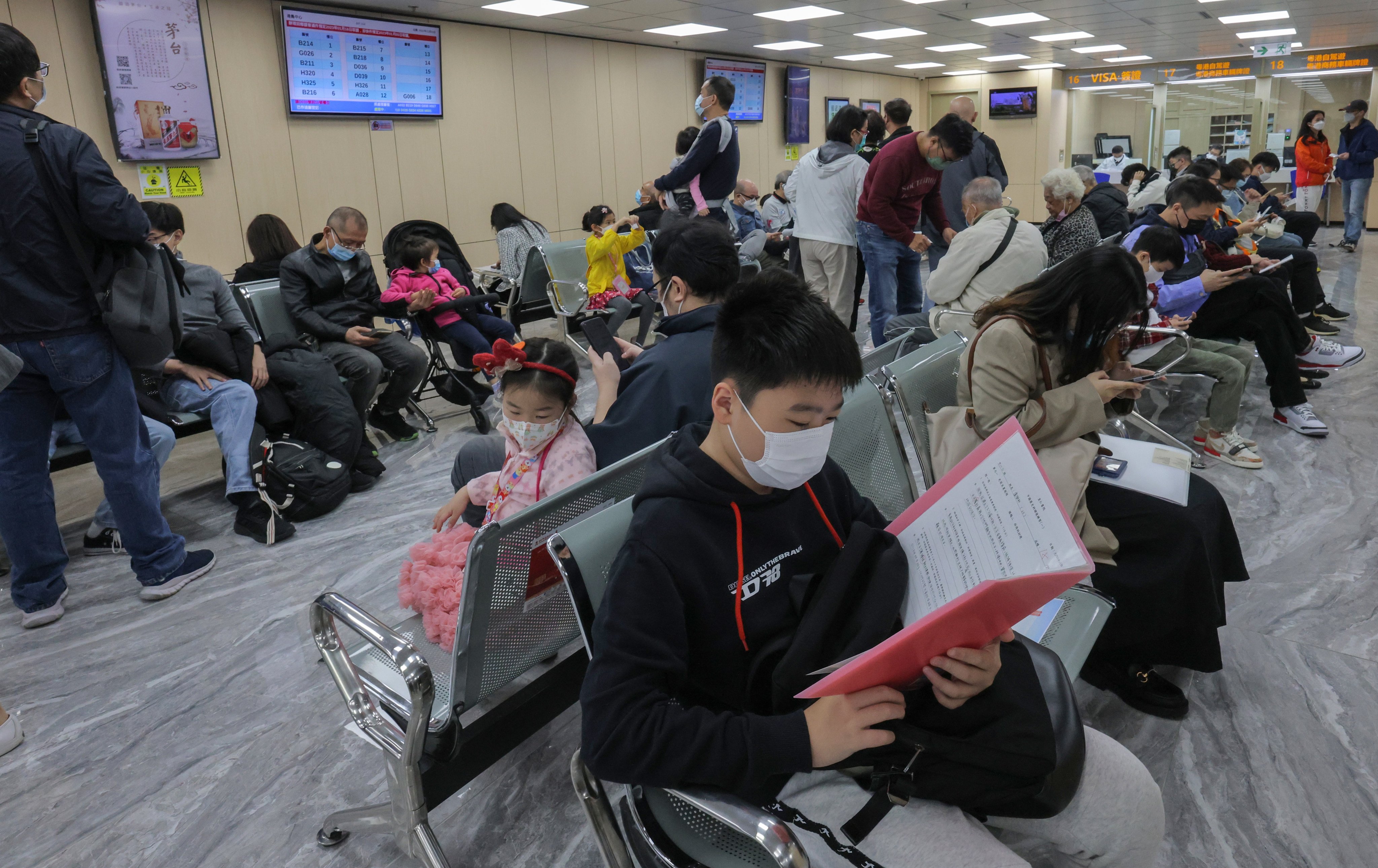 Crowds at a service centre for home permit applications in Hong Kong’s Sheung Wan. Photo: Jelly Tse