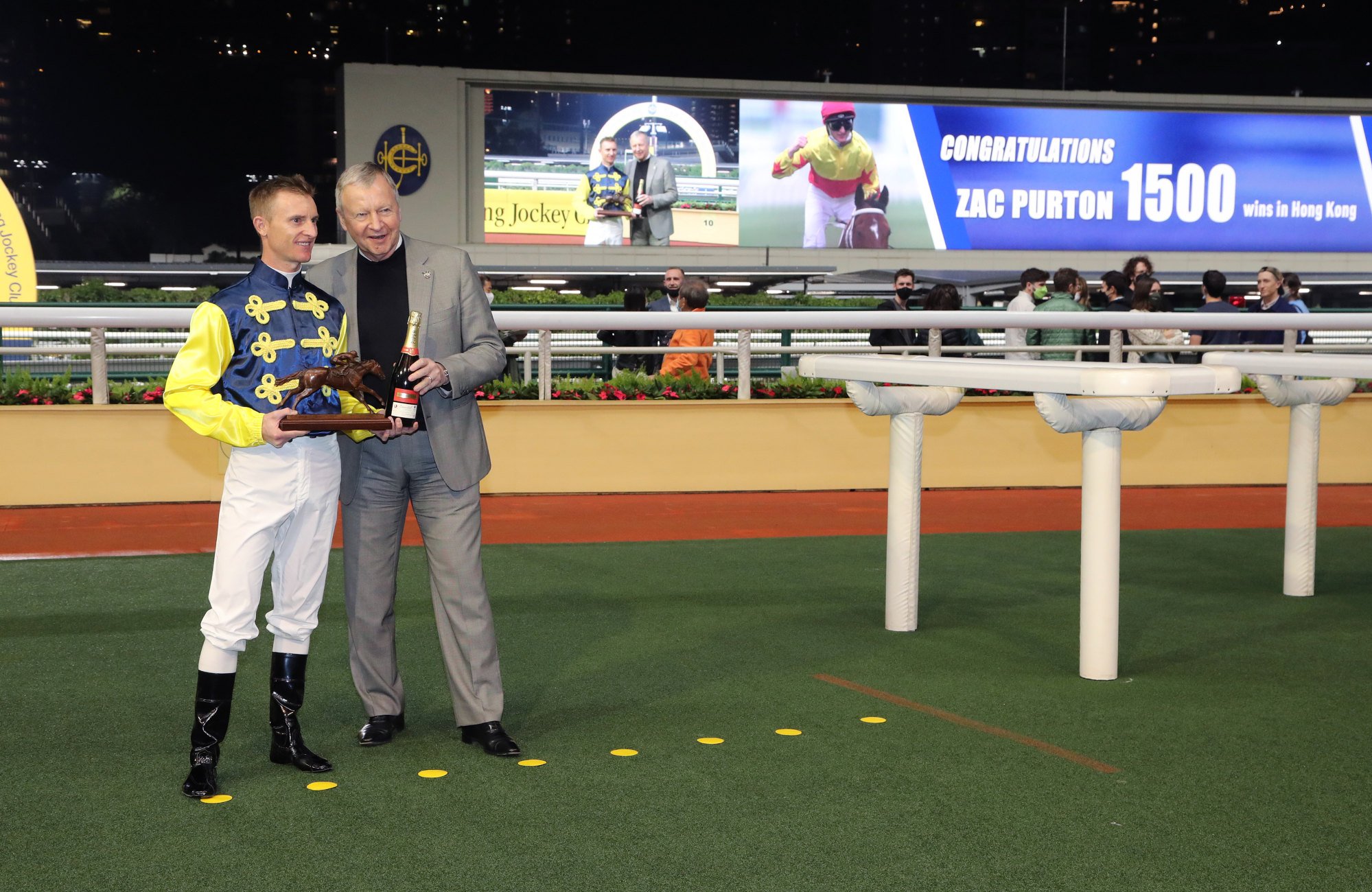 Jockey Club chief executive Winfried Engelbrecht-Bresges presents Zac Purton with souvenirs to mark his 1,500 wins in Hong Kong.