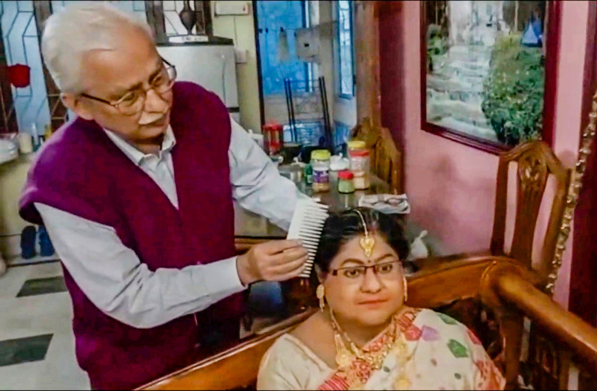 A screenshot of a video from Times of India showing Tapas Sandilya, 65, a retired government employee in Kolkata, with the lifelike silicone statue of his late wife in their home. Photo: The Times Of India