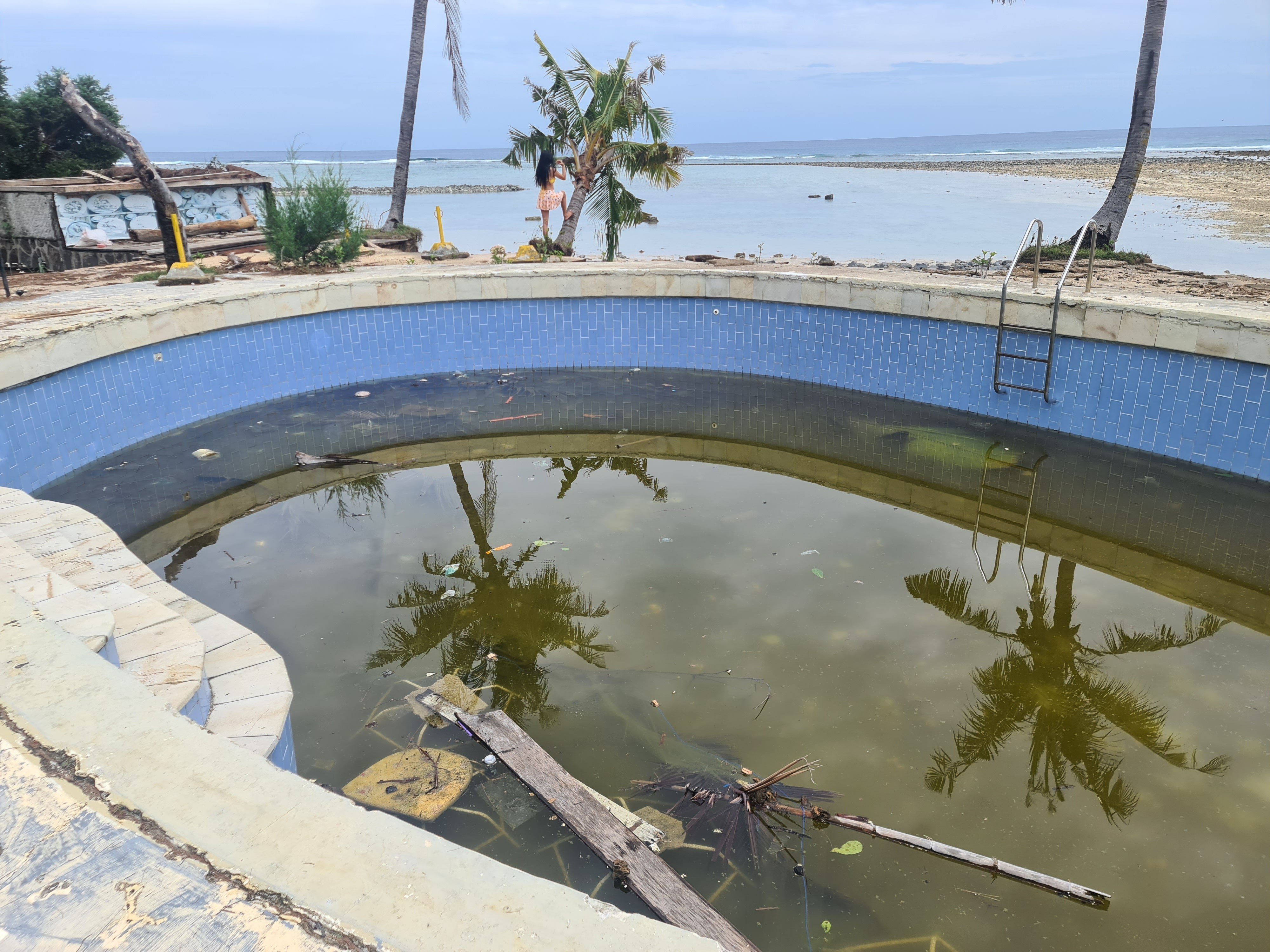 The rubbish-strewn pool of an abandoned resort on the Indonesian island of Gili Air after a tropical cyclone swept through on Christmas Day 2022. Photo: Dave Smith
