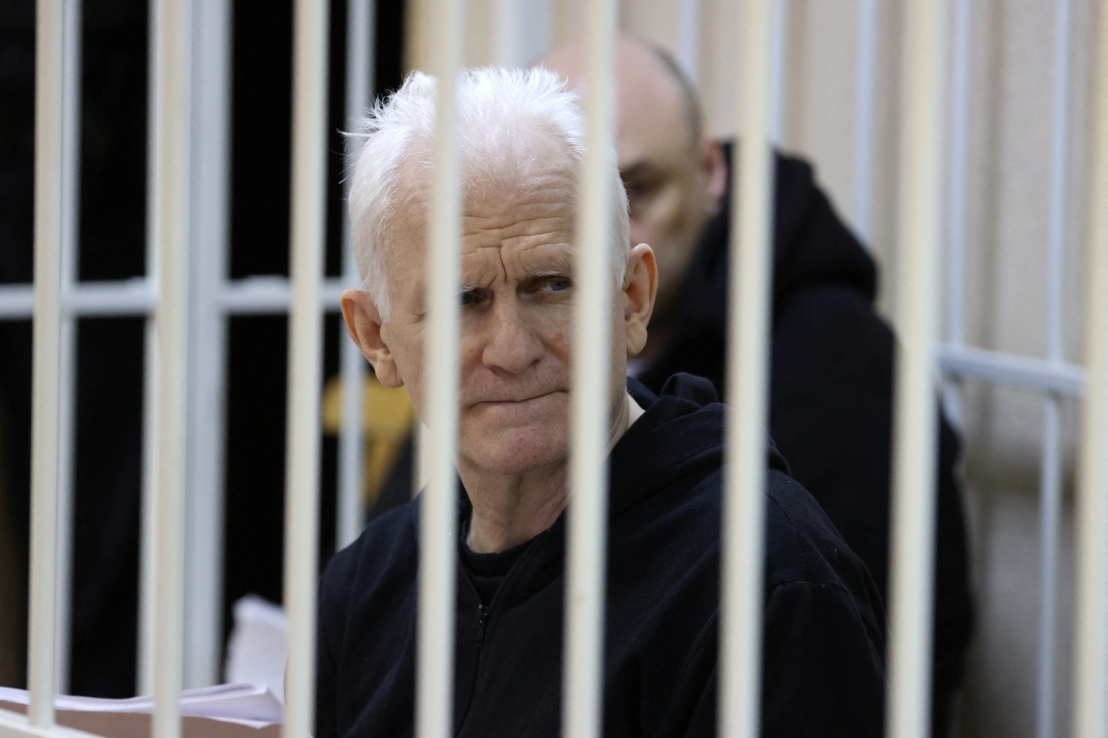 Nobel Peace Prize laureate Ales Byalyatski sits inside a defendants’ cage during a court hearing in Minsk, Belarus. Photo: Reuters