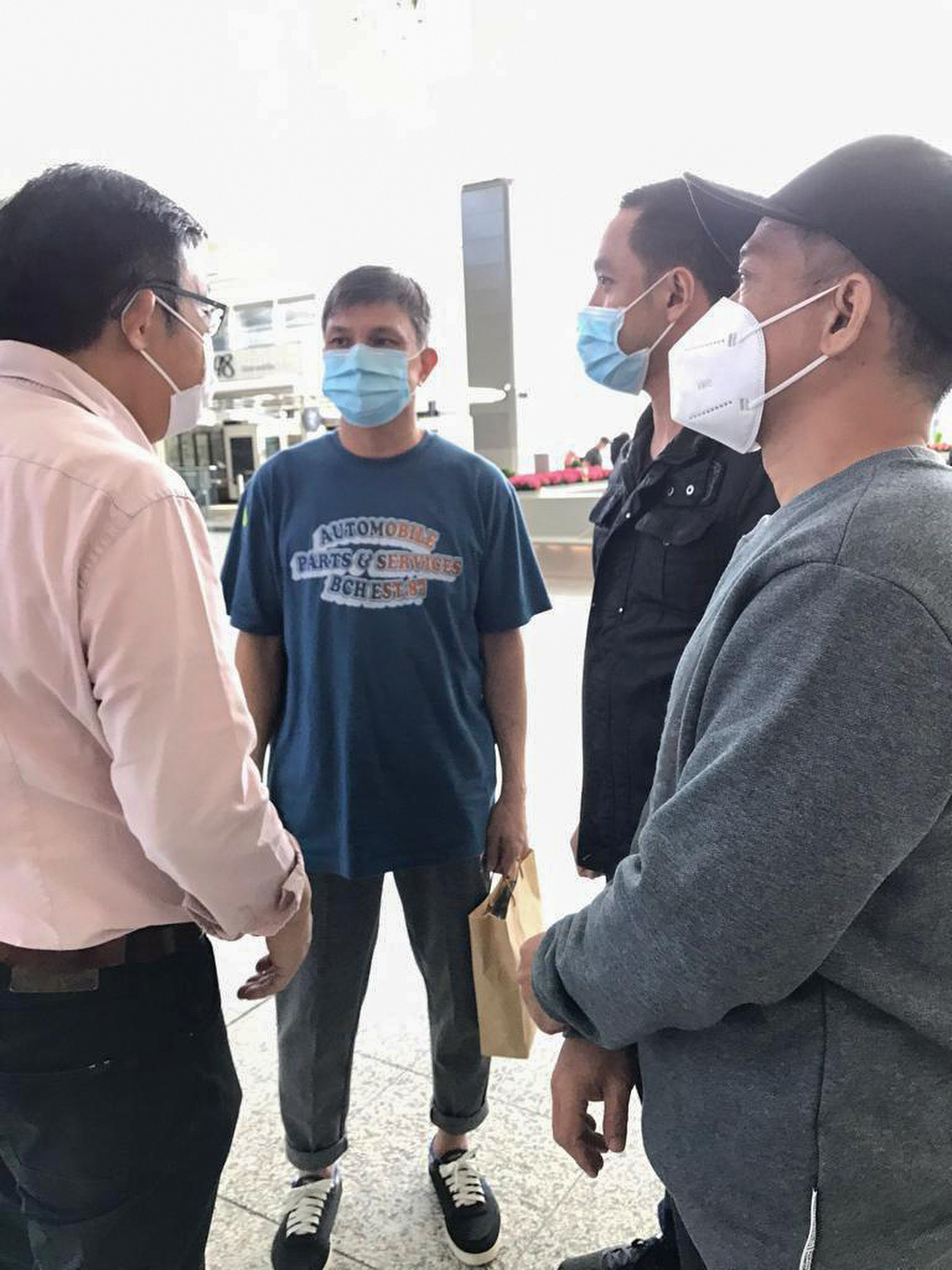 (L to R) Former lawmaker James To, who fought to free four men jailed in the Philippines on drug charges, greets three of them,  Kwok Kam-wah , Chan Kwok-tung and Lo Wing-fai, at the airport on Friday after they were released in the wake of successful appeals. Leung Shu-Fook, whose appeal was unsuccessful, is still in prison. Photo: Handout 