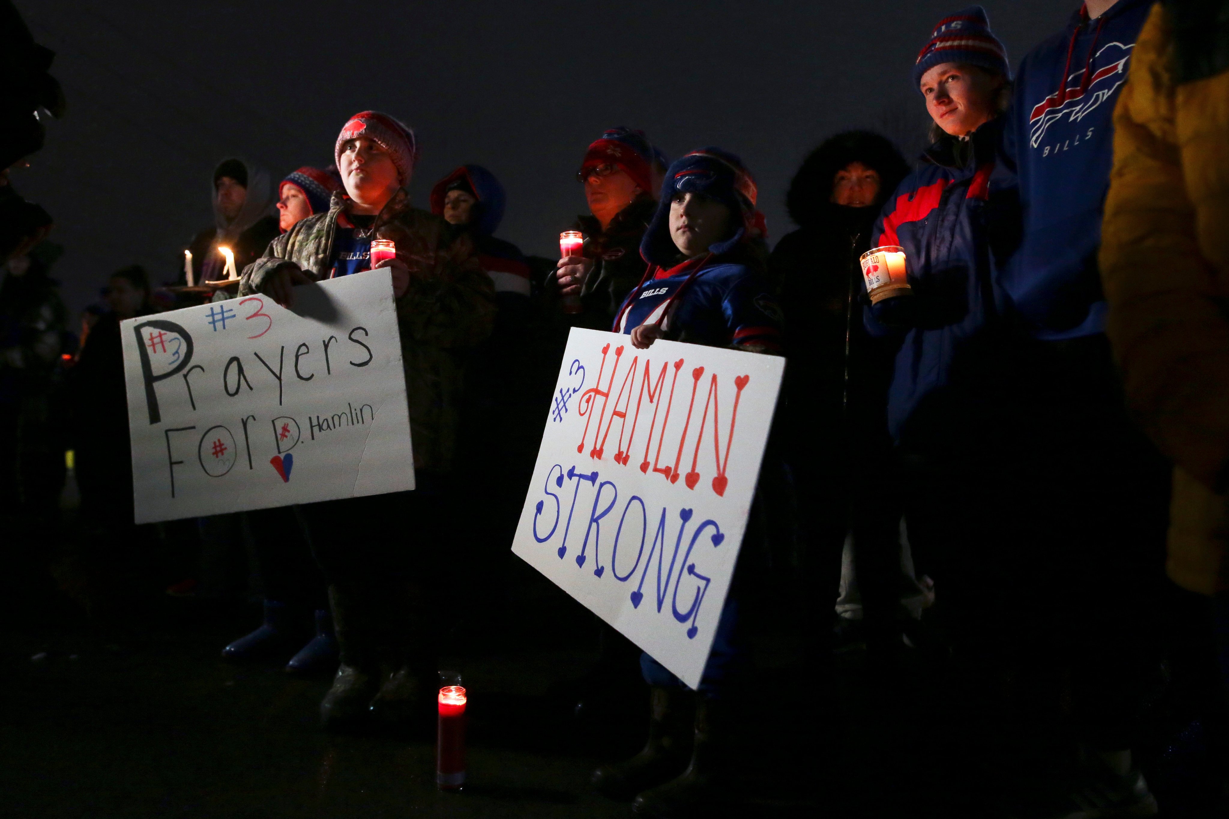 Fans hold a candlelight vigil for Buffalo Bills safety Damar Hamlin. Photo: AP