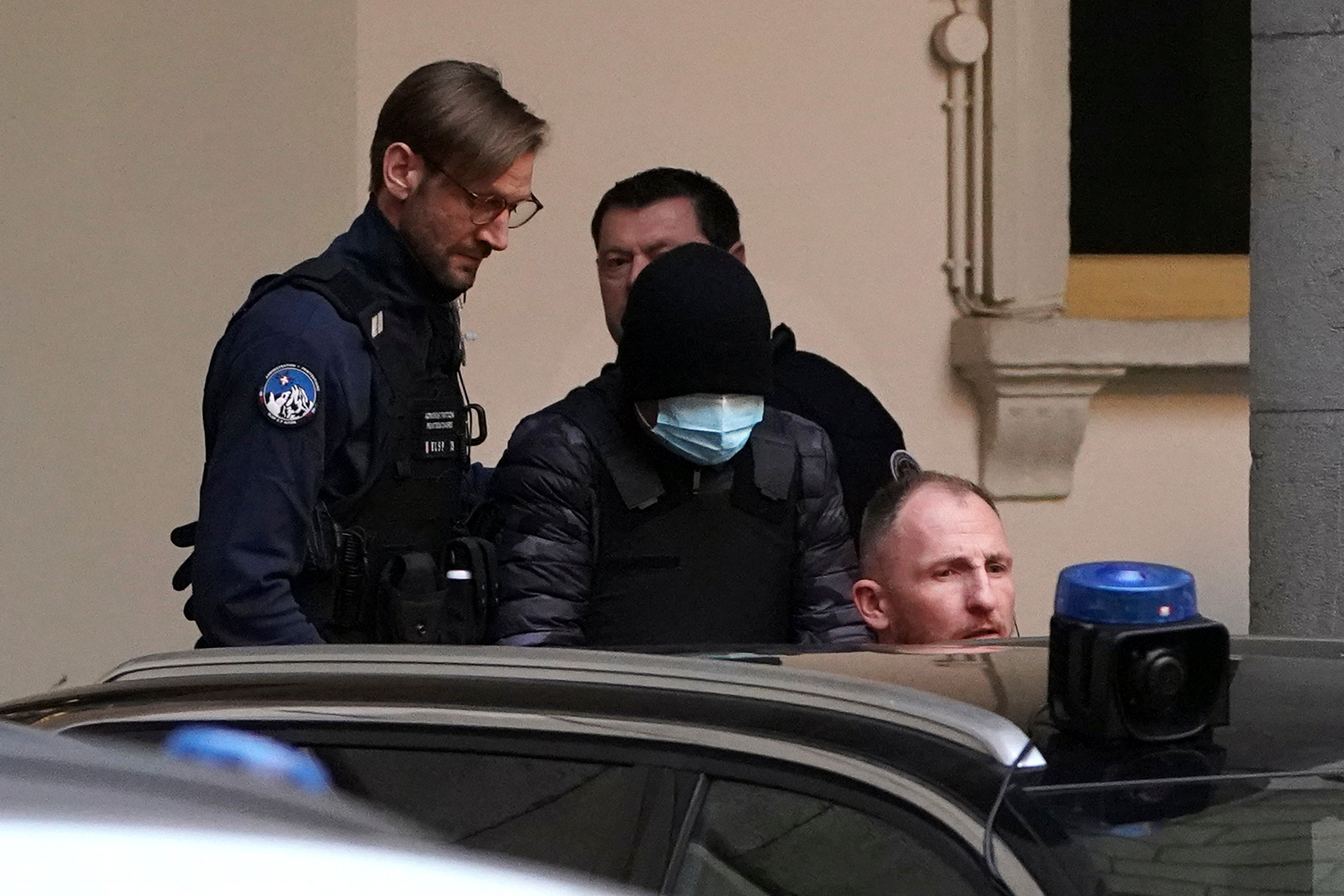 Ukrainian businessman and former politician Kostiantyn Zhevago, wearing a mask and a cap (centre), after appearing at the court house of Chambery in the French Alps on Thursday. Photo: AP