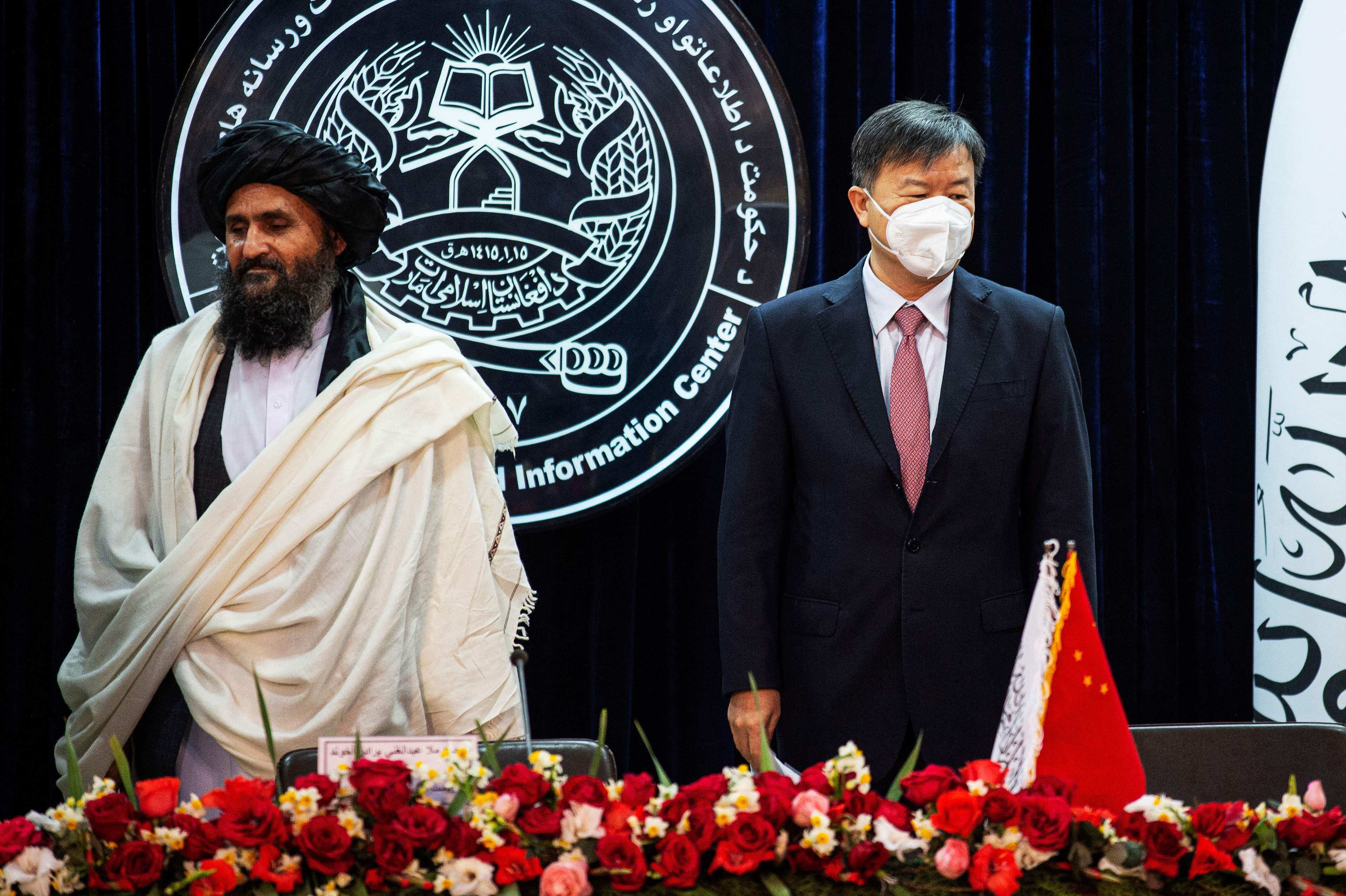 Afghanistan’s acting first deputy prime minister Abdul Ghani Baradar (left) and China’s ambassador to Afghanistan Wang Yu attend a press conference to announce an oil extraction contract with a Chinese company in Kabul on January 5, 2023. Photo: AFP