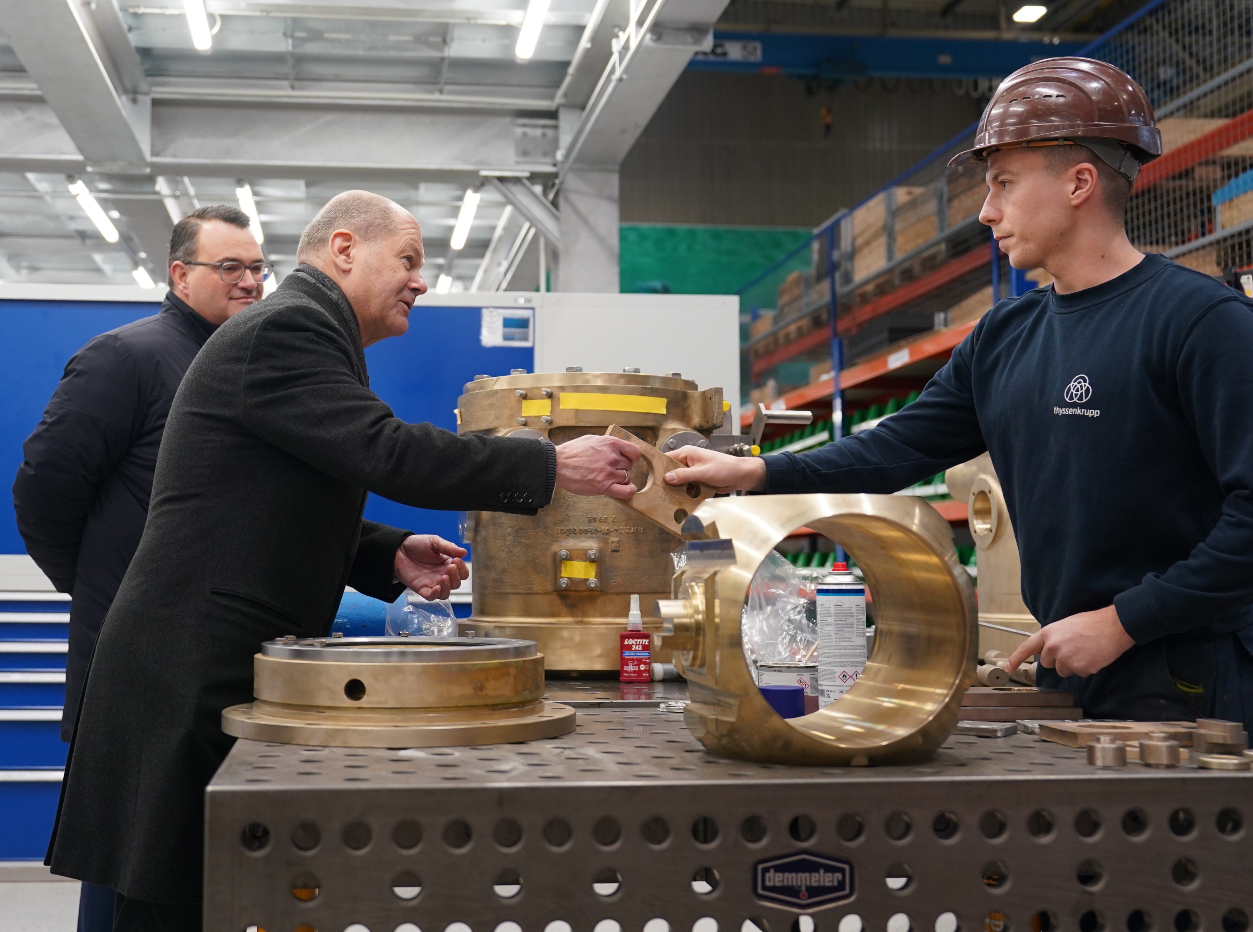 German Chancellor Olaf Scholz (second left) meets employees during a factory tour at the Thyssenkrupp Marine Systems shipyard in Kiel, Germany, on December 13, 2022. Photo: EPA-EFE