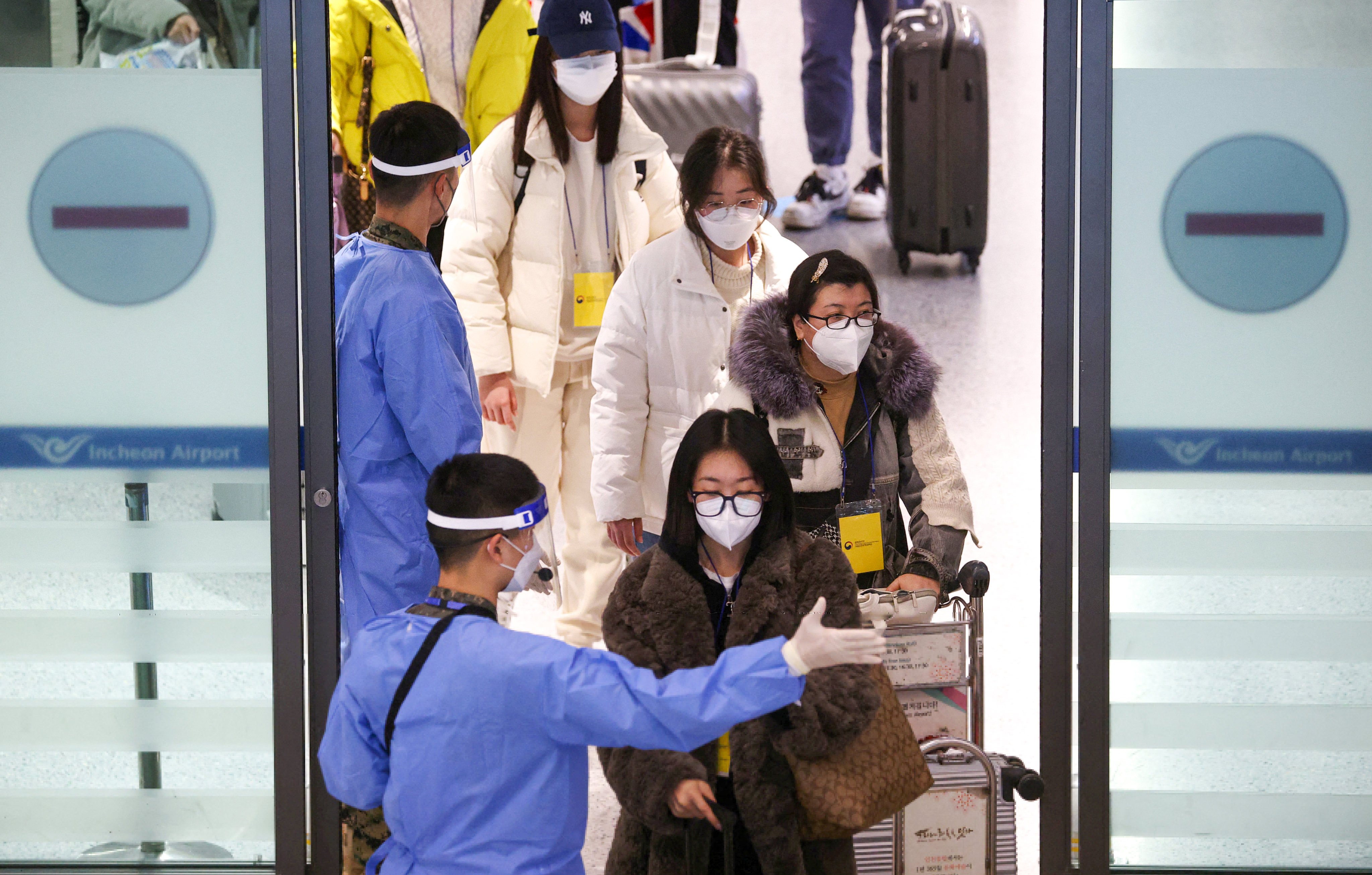 Chinese tourists are guided to get tested on arrival at Seoul’s Incheon International Airport in South Korea on January 4. Photo: Reuters