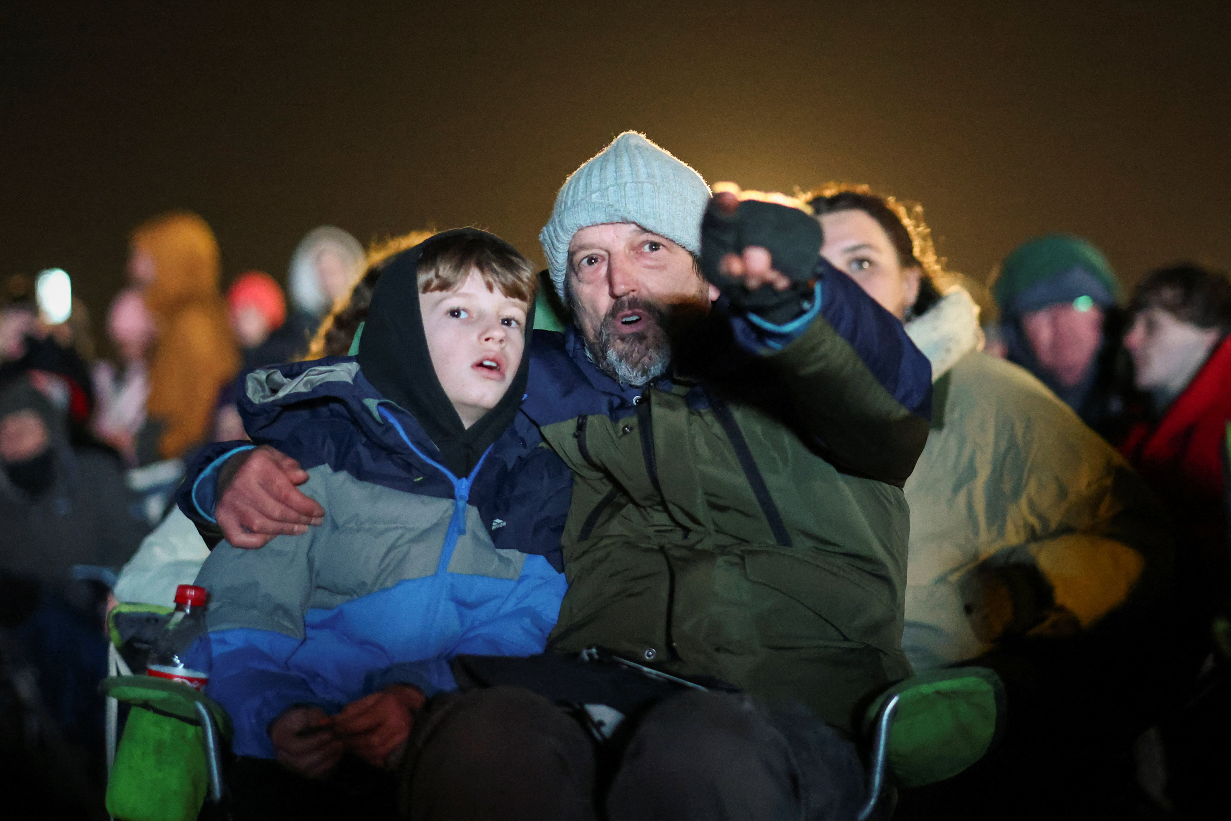 A man and a child watch the attempted satellite launch on a screen, at Cornwall Airport Newquay, in Cornwall, Britain. Photo: Reuters