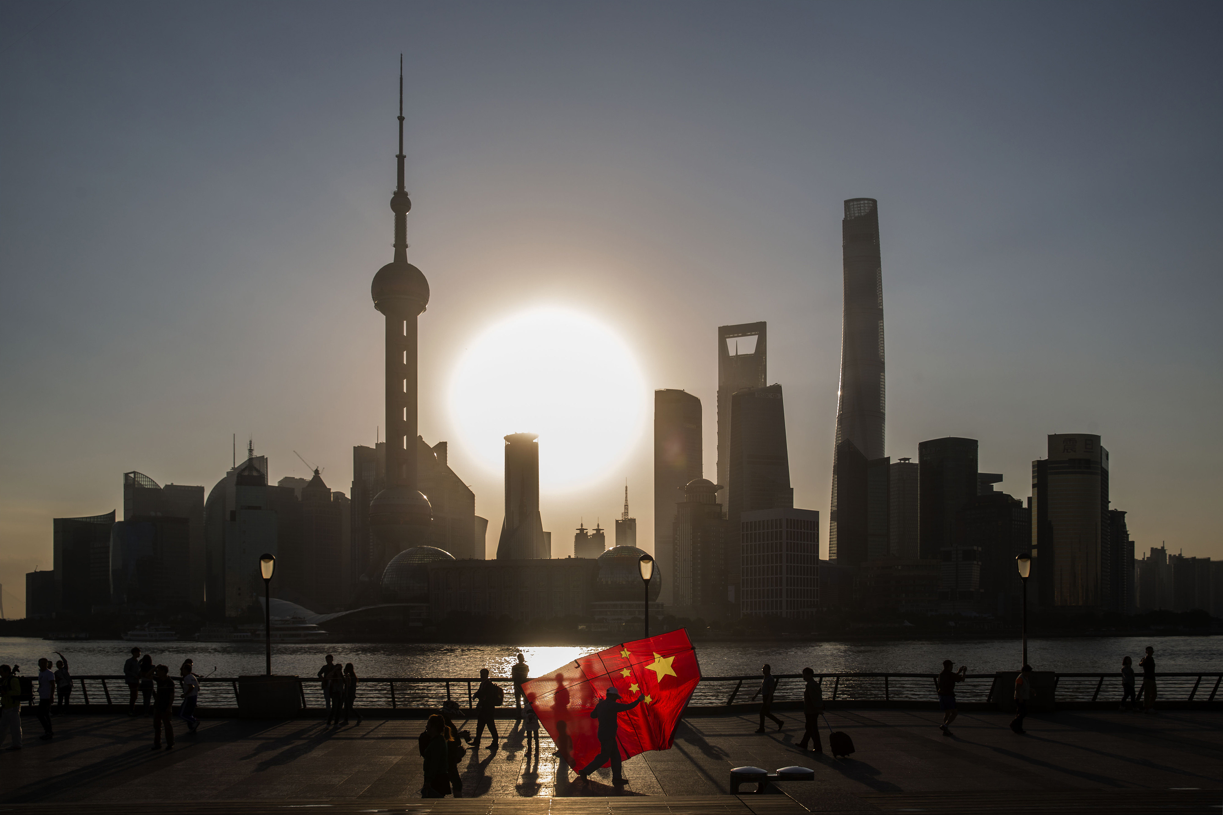 A man carries a kite in the shape of the Chinese national flag in Shanghai. None of the Chinese banks that are part of the MSCI ACWI global equity index have carried out analysis of climate scenarios, to estimate the financial impact of various degrees of global warming. Photo: Bloomberg