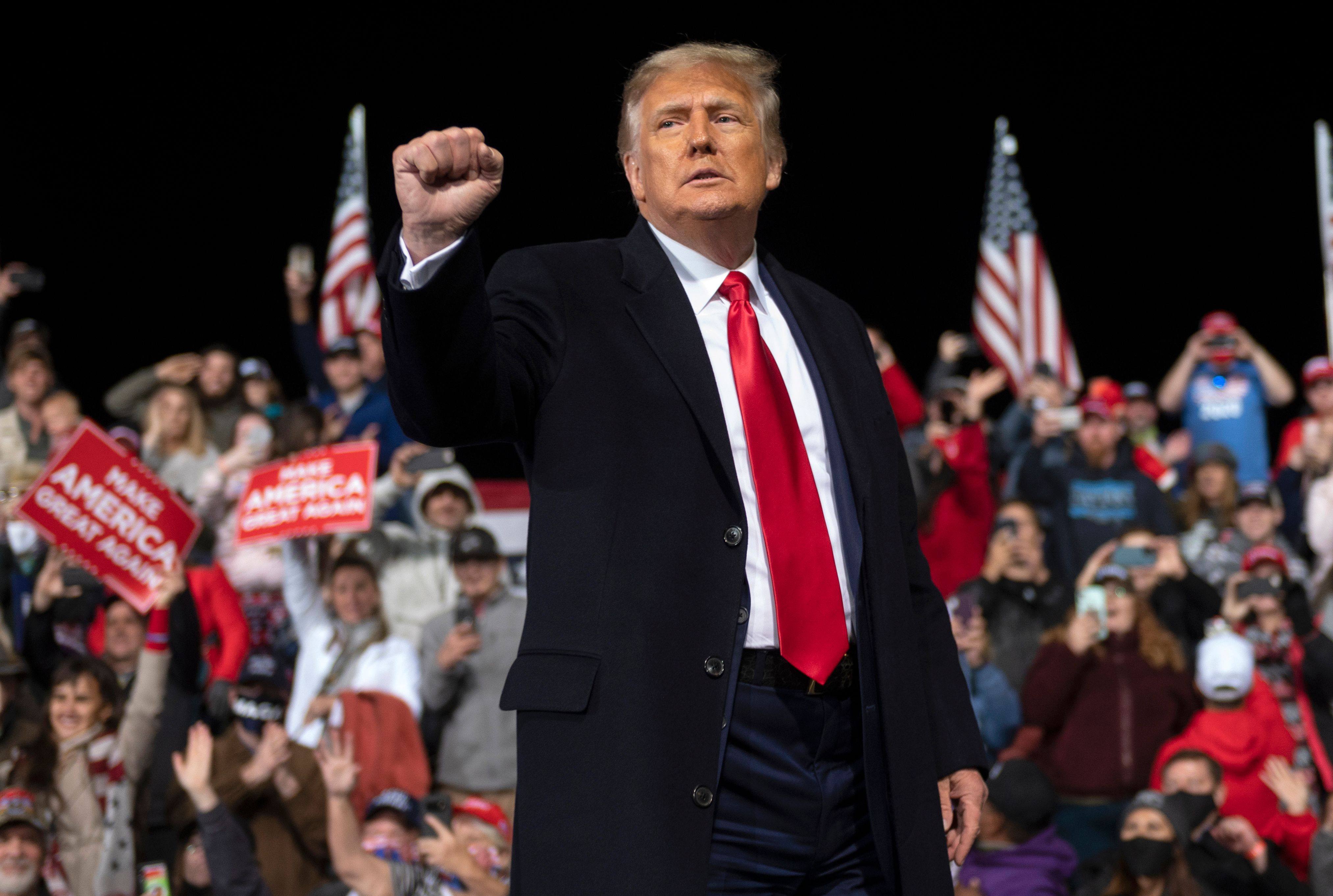 US President Donald Trump holds up his fist as he leaves the stage at the end of a rally in Valdosta, Georgia, in December 2020. Photo: AFP via TNS