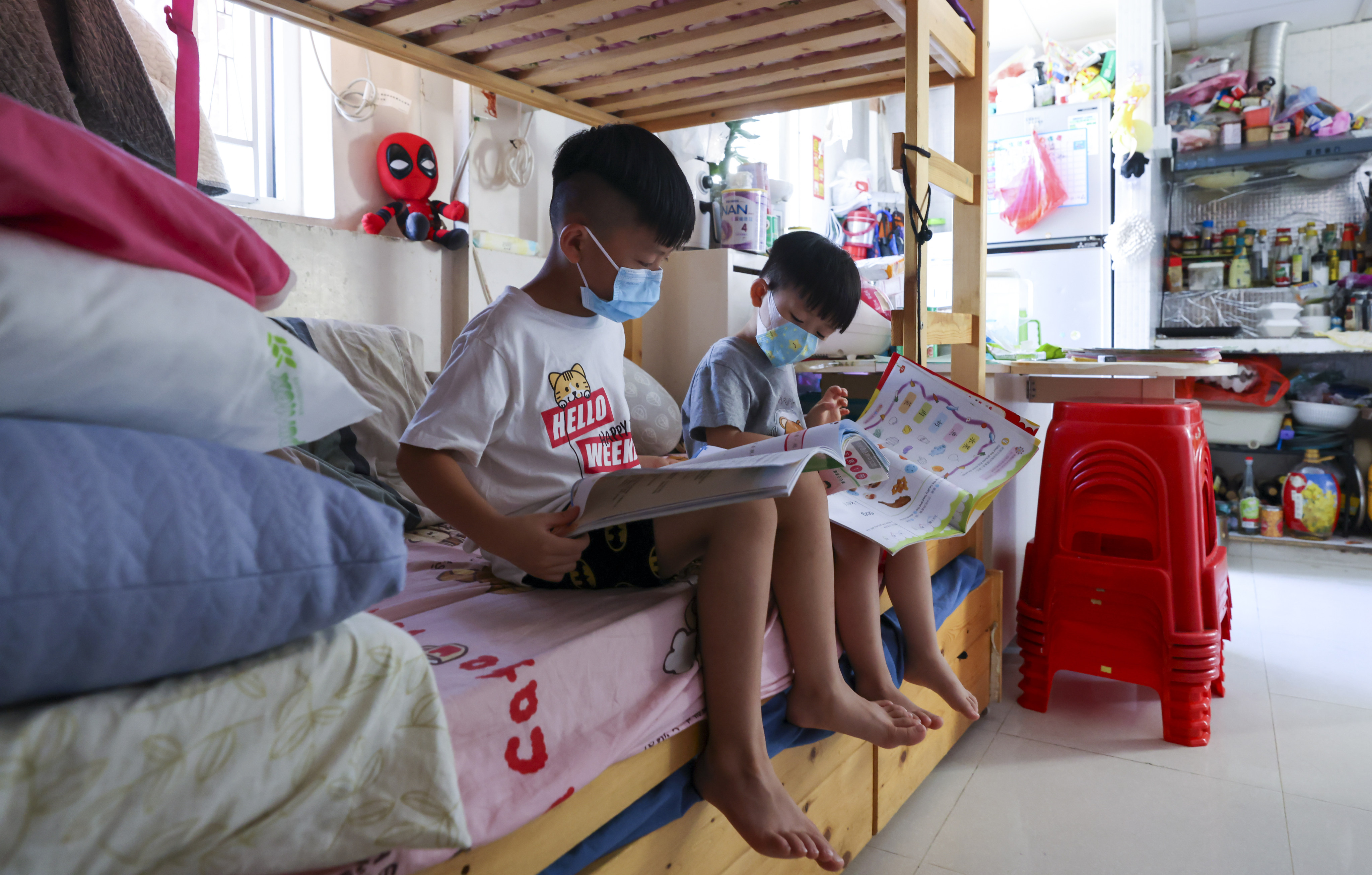 Unprivileged children do homework in Sham Shui Po on August 22, 2022. The government has unveiled the Strive and Rise Programme to help address intergenerational poverty.  Photo: Nora Tam