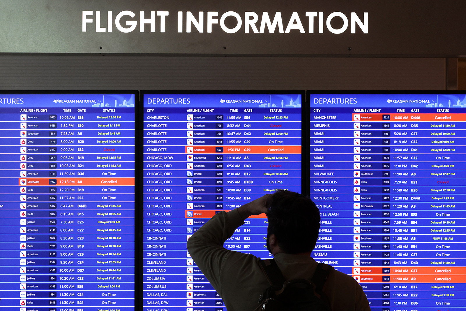 A traveller looks at a flight information board at Ronald Reagan Washington National Airport in Arlington, Virginia, on Wednesday. Photo: TNS