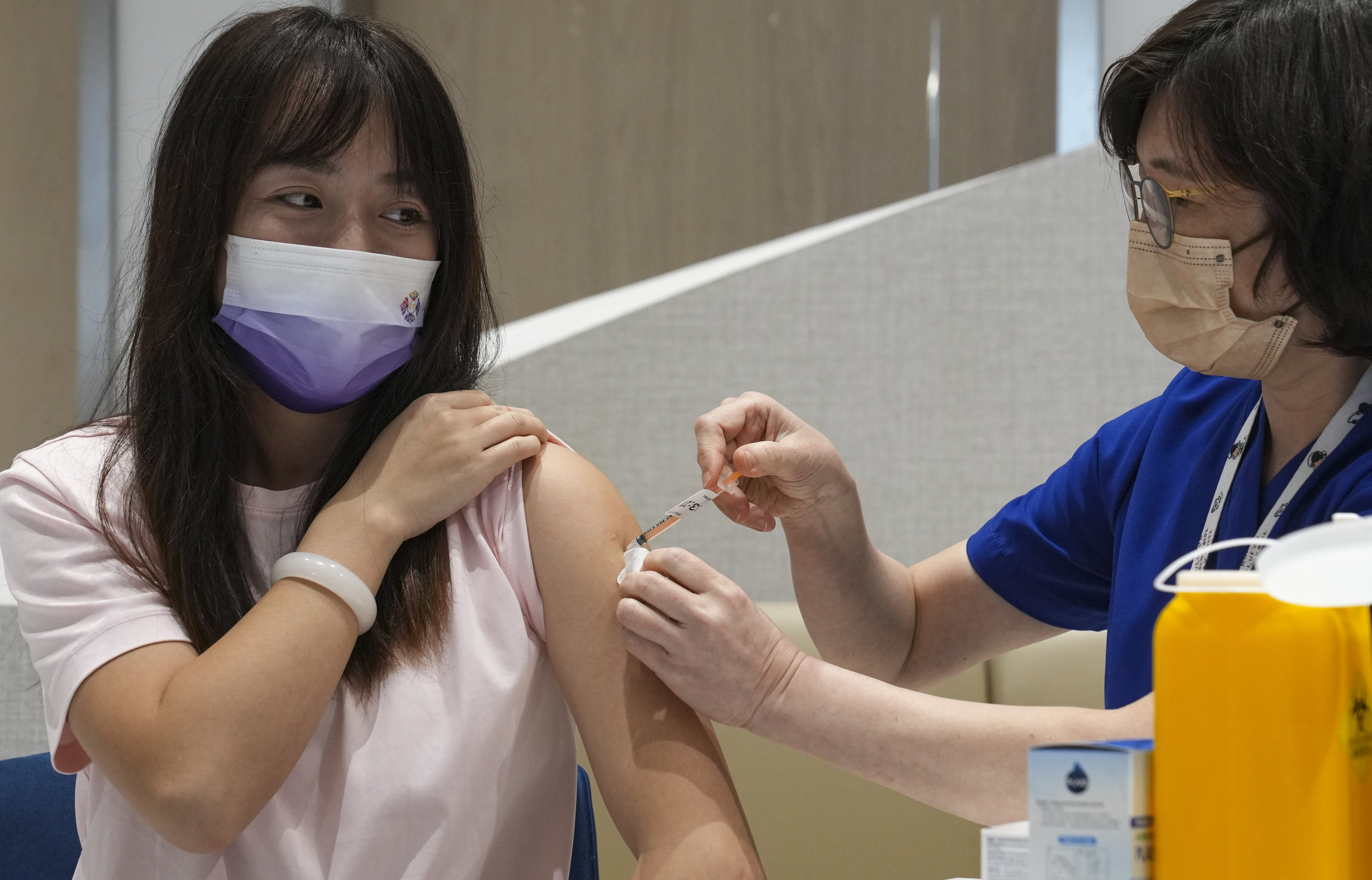 A patient receives a dose of the bivalent vaccine at a private clinic in Tsim Sha Tsui. Photo: Sam Tsang