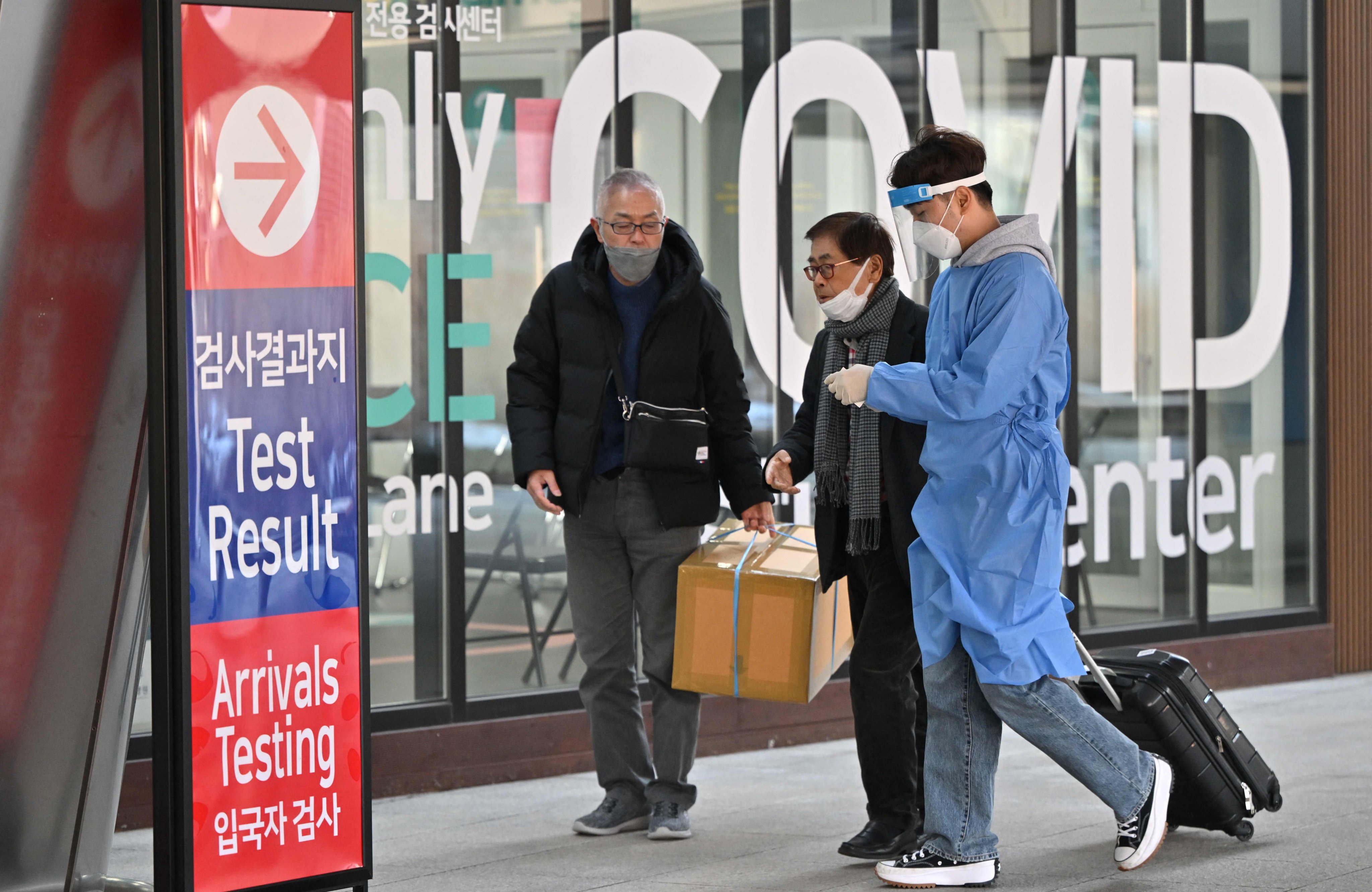 A health worker guides travellers arriving from China at a Covid-19 testing centre at Incheon International Airport in South Korea on January 3. Photo: AFP